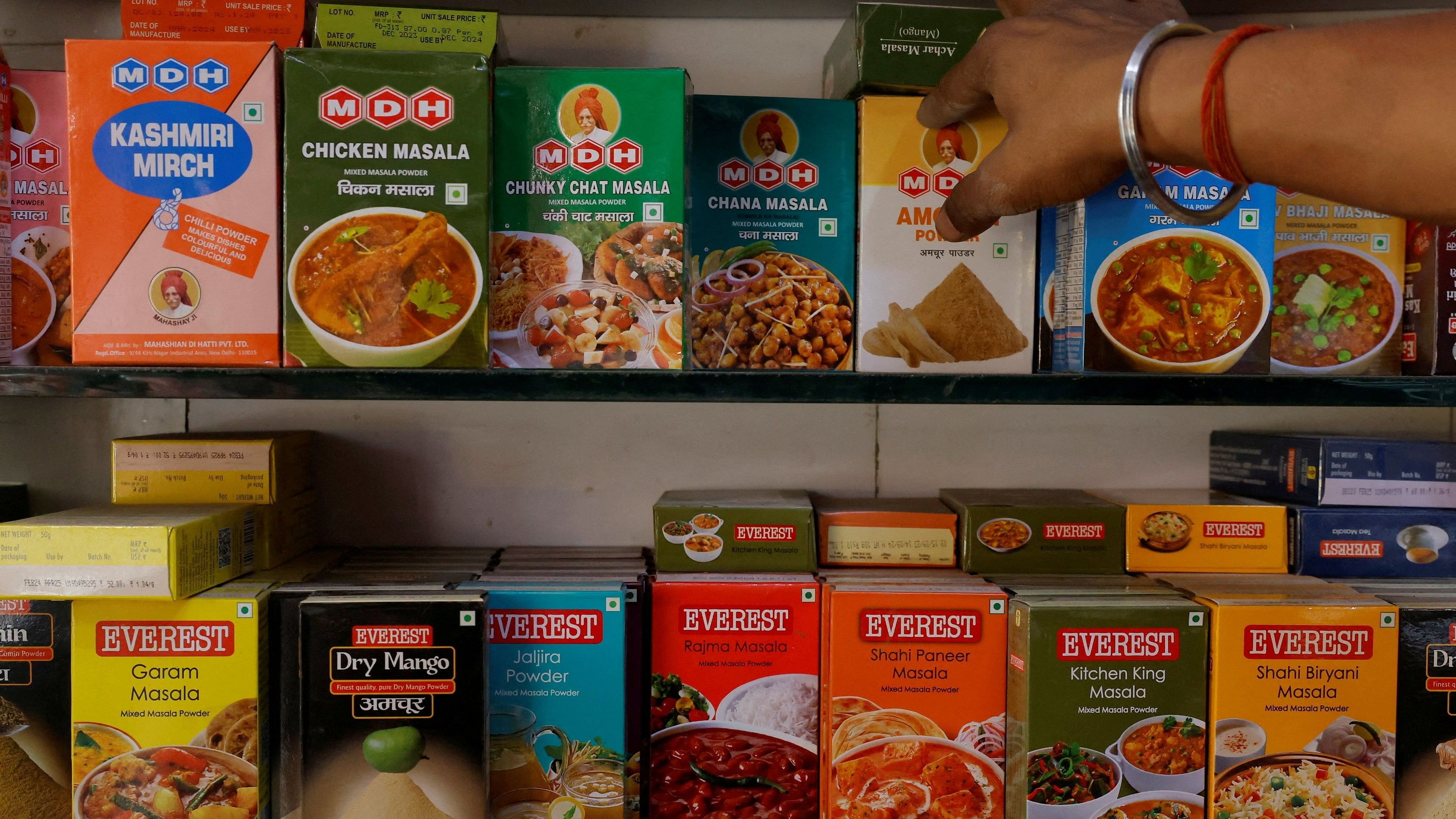 <div class="paragraphs"><p>A man adjusts the spice boxes of MDH and Everest on the shelf of a shop at a market in New Delhi, India, April 29, 2024. </p></div>