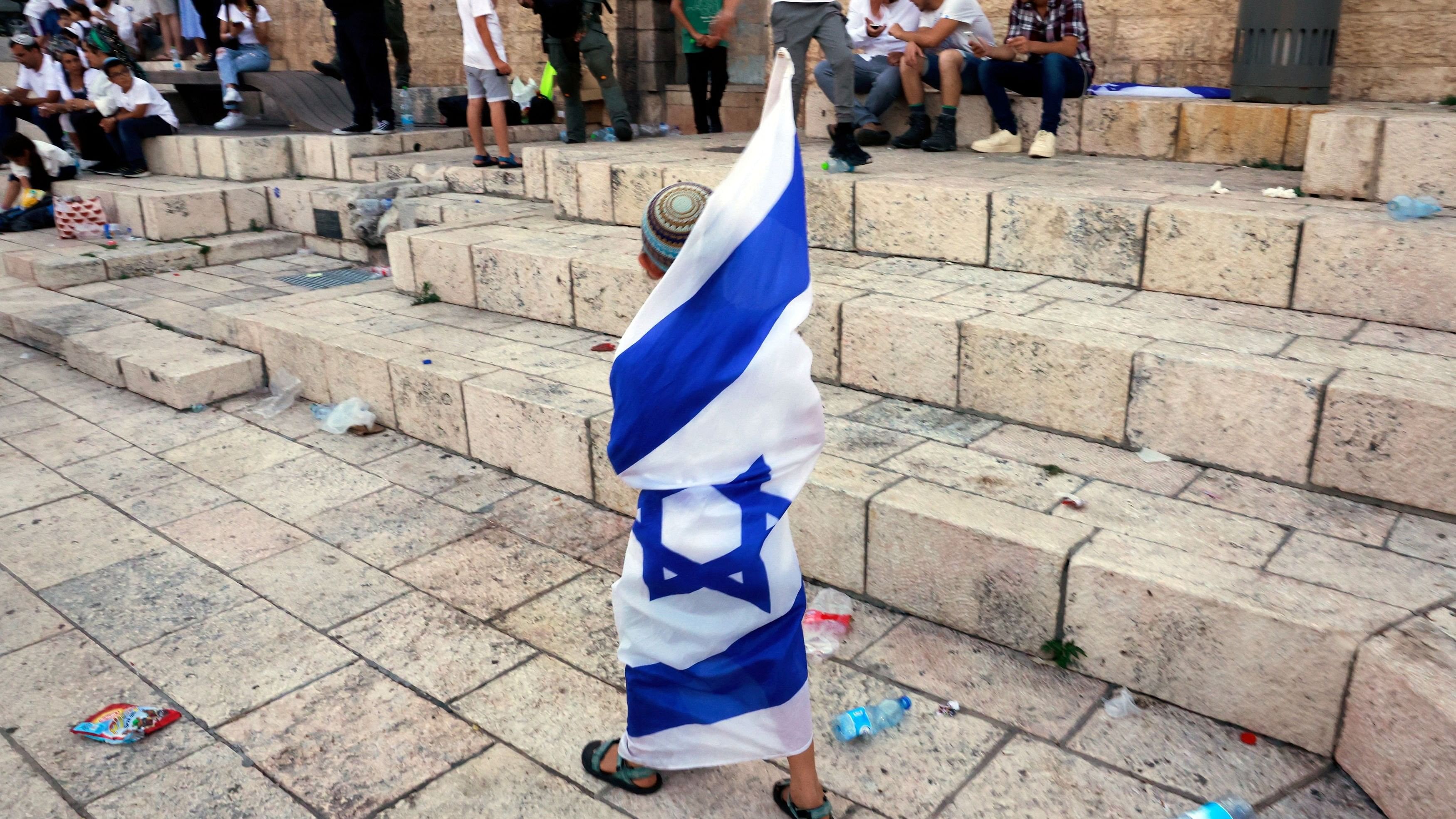 <div class="paragraphs"><p>A boy wrapped in an Israeli flag attends the annual Jerusalem Day march, amid the ongoing conflict in Gaza between Israel and Hamas, at Damascus Gate in Jerusalem, June 5, 2024. </p></div>