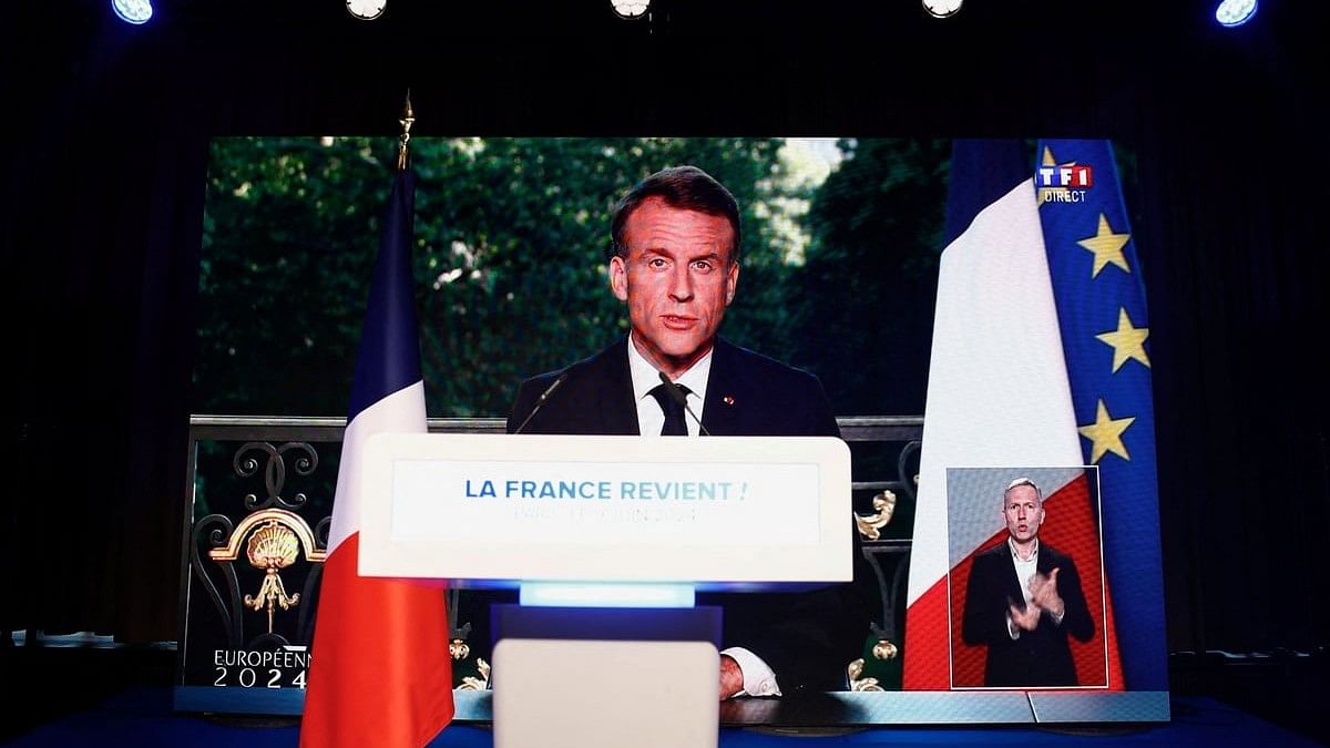 <div class="paragraphs"><p>French President Emmanuel Macron speaks through a screen at the far-right National Rally  party headquarters after the polls closed during the European Parliament elections, in Paris, France.</p></div>