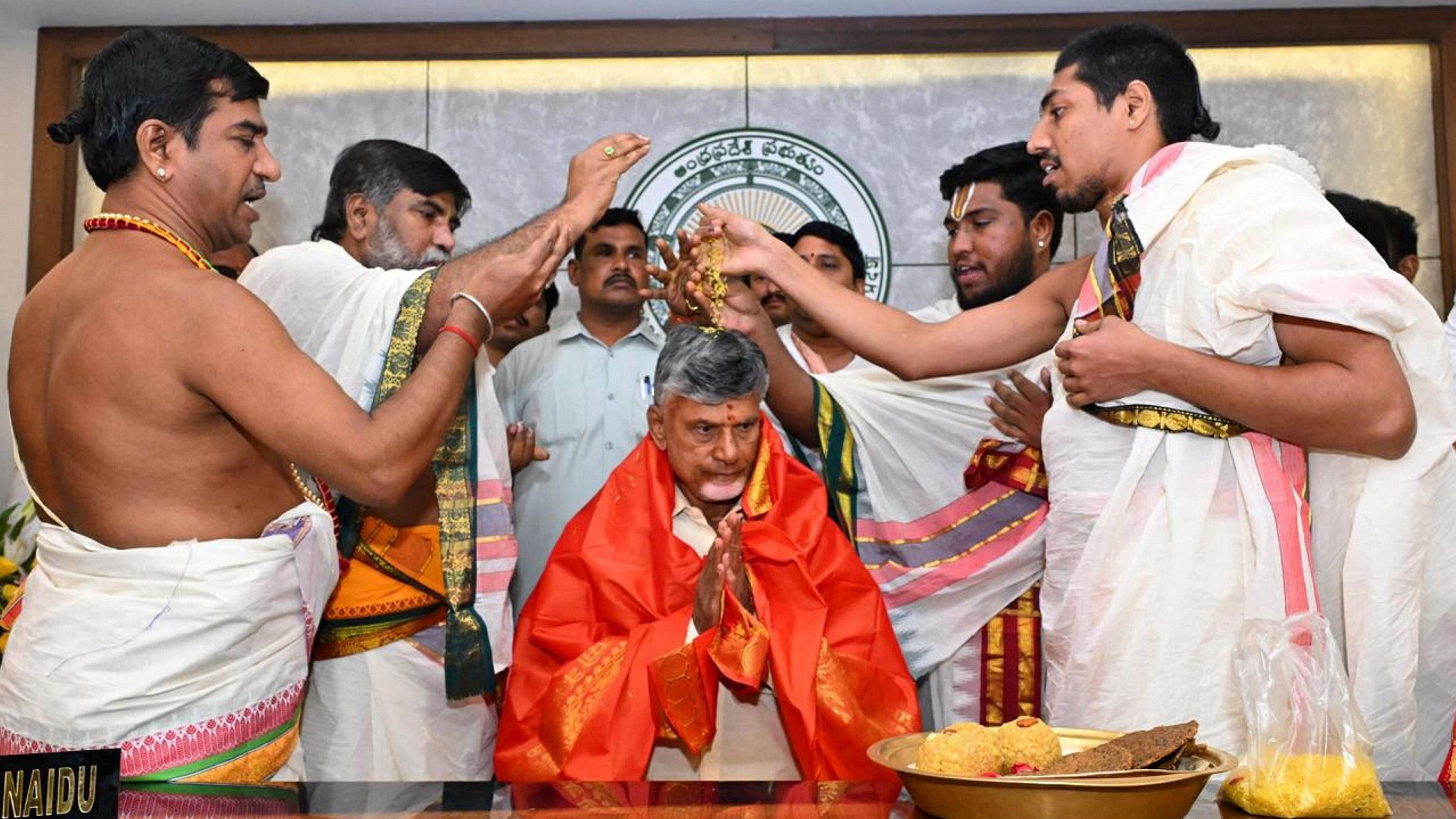 <div class="paragraphs"><p>Andhra Pradesh Chief Minister Nara Chandrababu Naidu takes part in a prayer ceremony before taking charge at his office at Tadepalli, Amaravati, Thursday.</p></div>