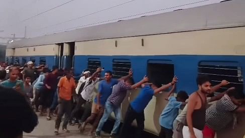 <div class="paragraphs"><p>Screengrab of video showing people pushing the train</p></div>