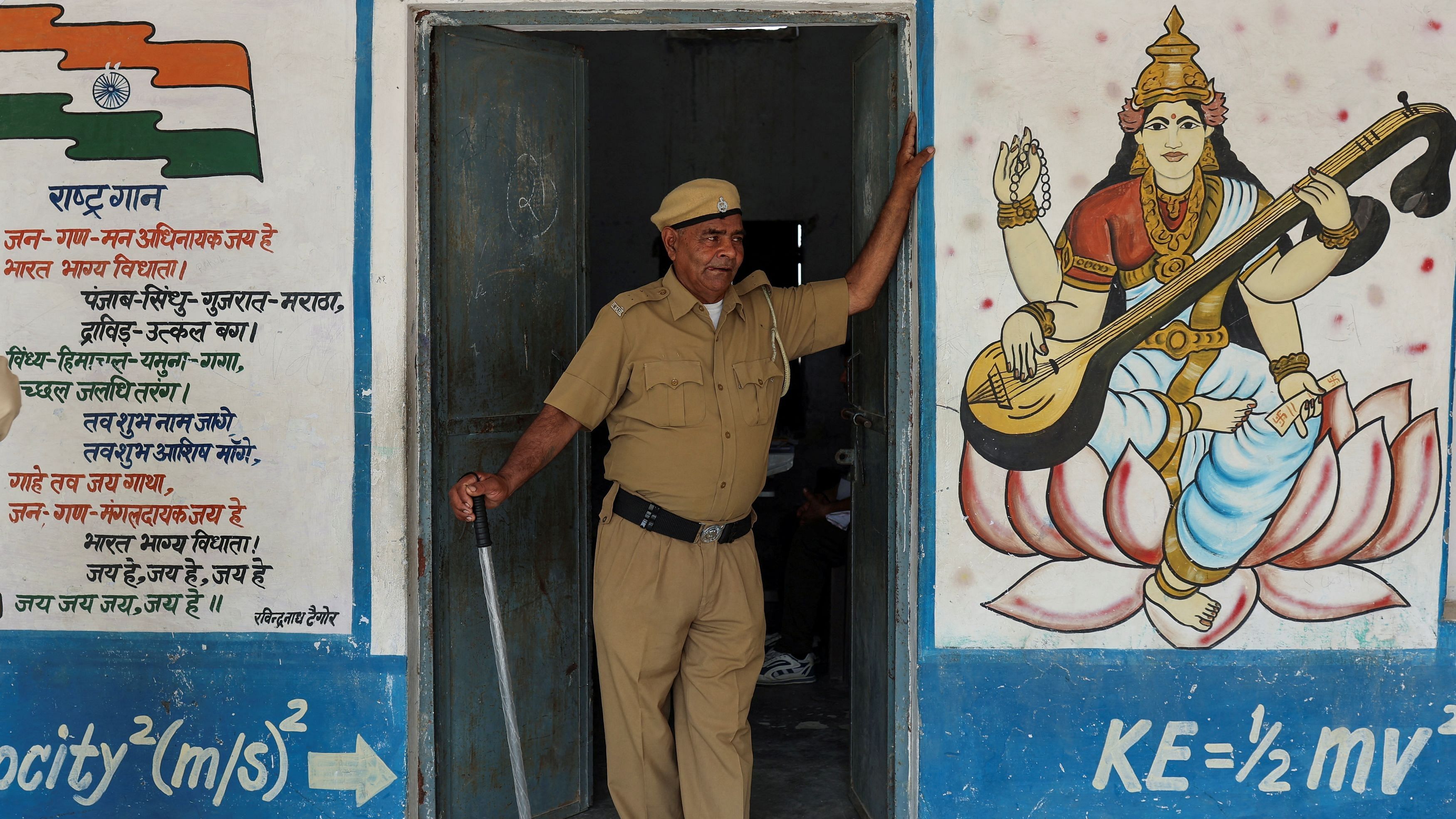 <div class="paragraphs"><p>A police officer stands guard at the doorway of a polling station during the sixth phase of the general election in Sonipat, in the northern Indian state of Haryana, India, May 25, 2024.</p></div>