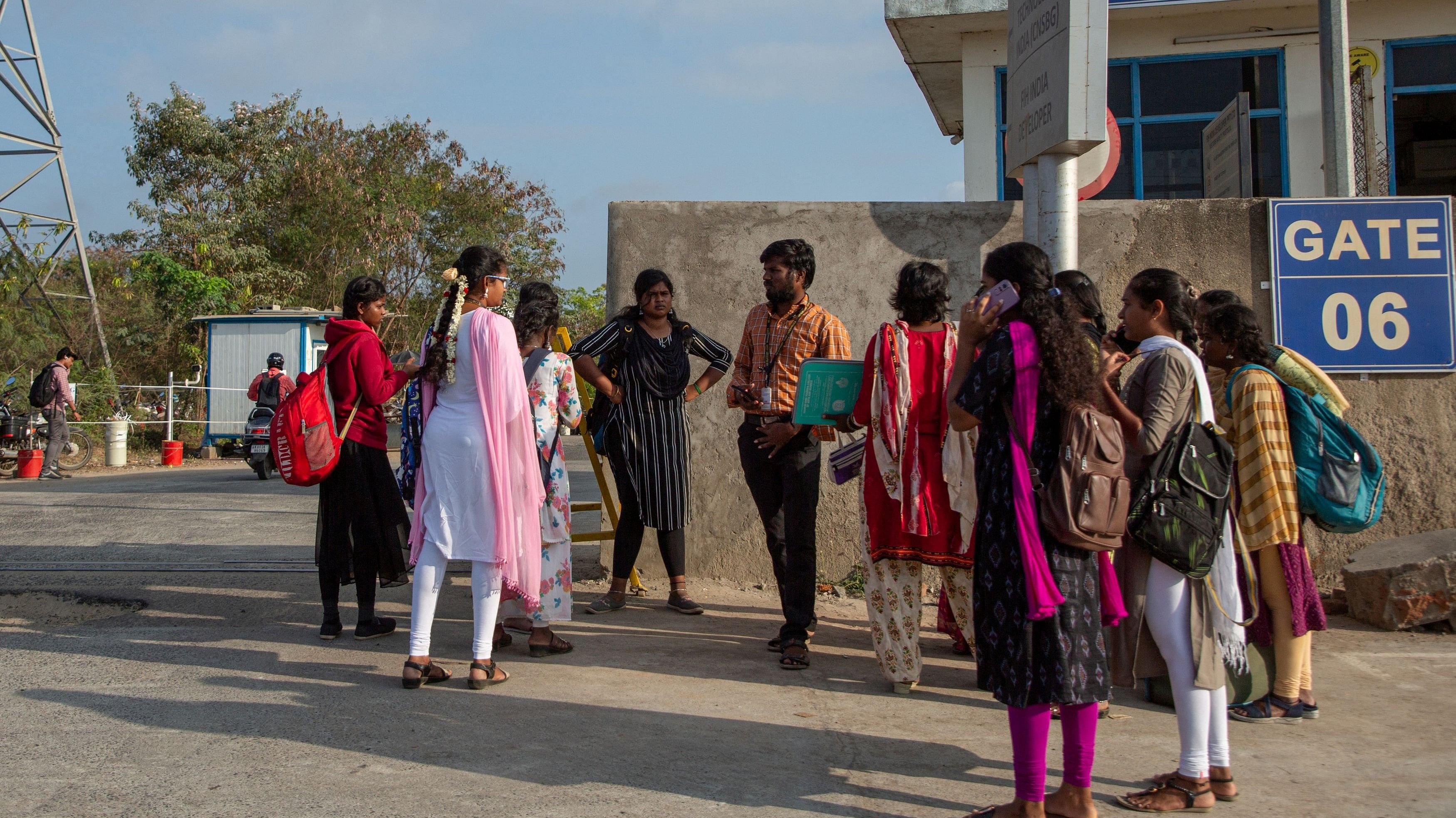 <div class="paragraphs"><p>Job aspirants talk with a hiring agent outside the Foxconn plant in Sriperumbudur.</p></div>