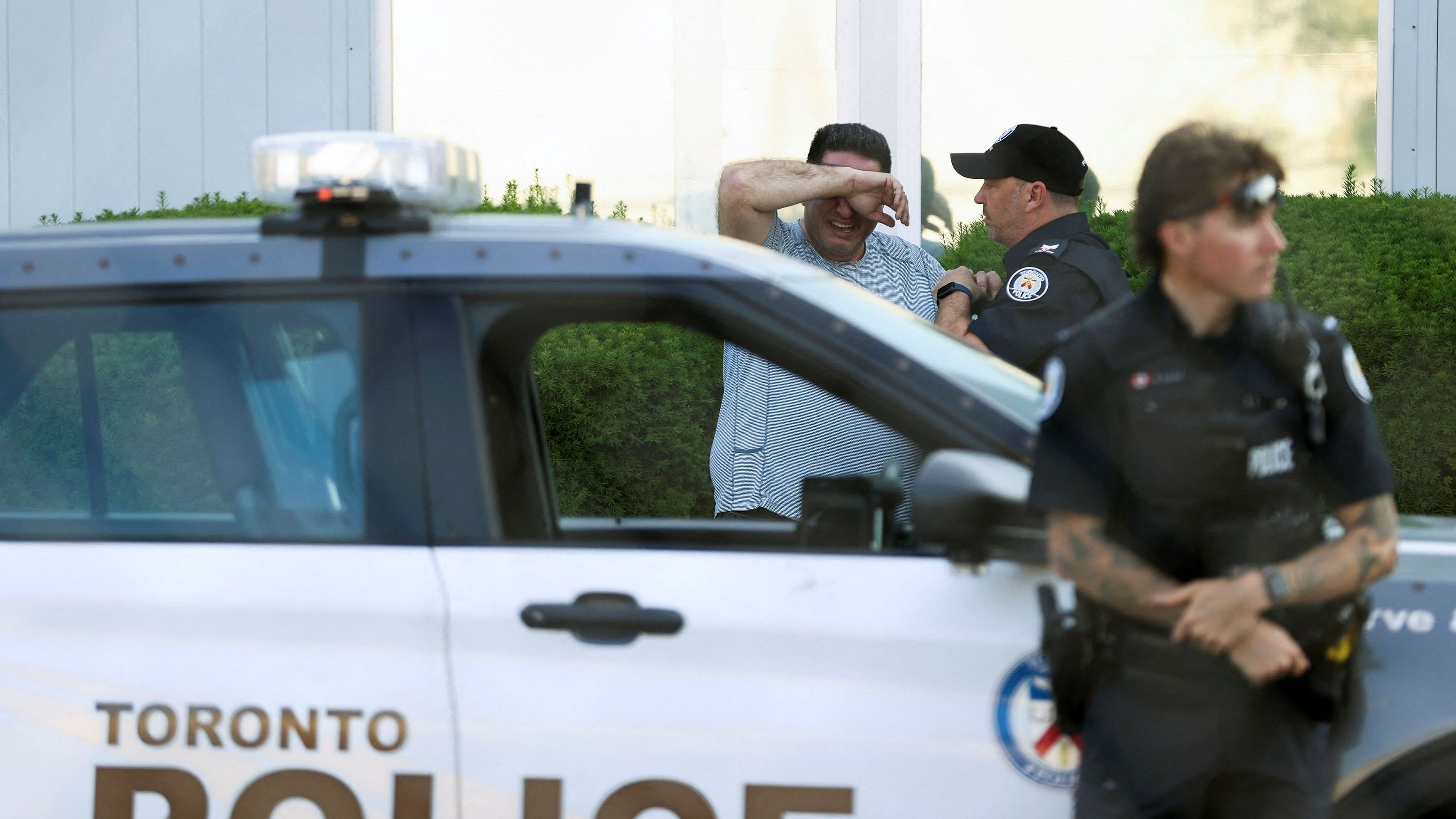 <div class="paragraphs"><p>A man covers his face as he talks to police outside the scene of a deadly shooting at an office building in the Don Mills neighborhood of Toronto, Ontario, Canada June 17, 2024.</p></div>