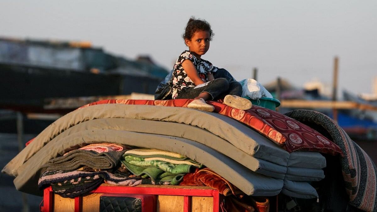 <div class="paragraphs"><p>A Palestinian sits on top of belongings as he flees Rafah due to an Israeli military operation</p></div>