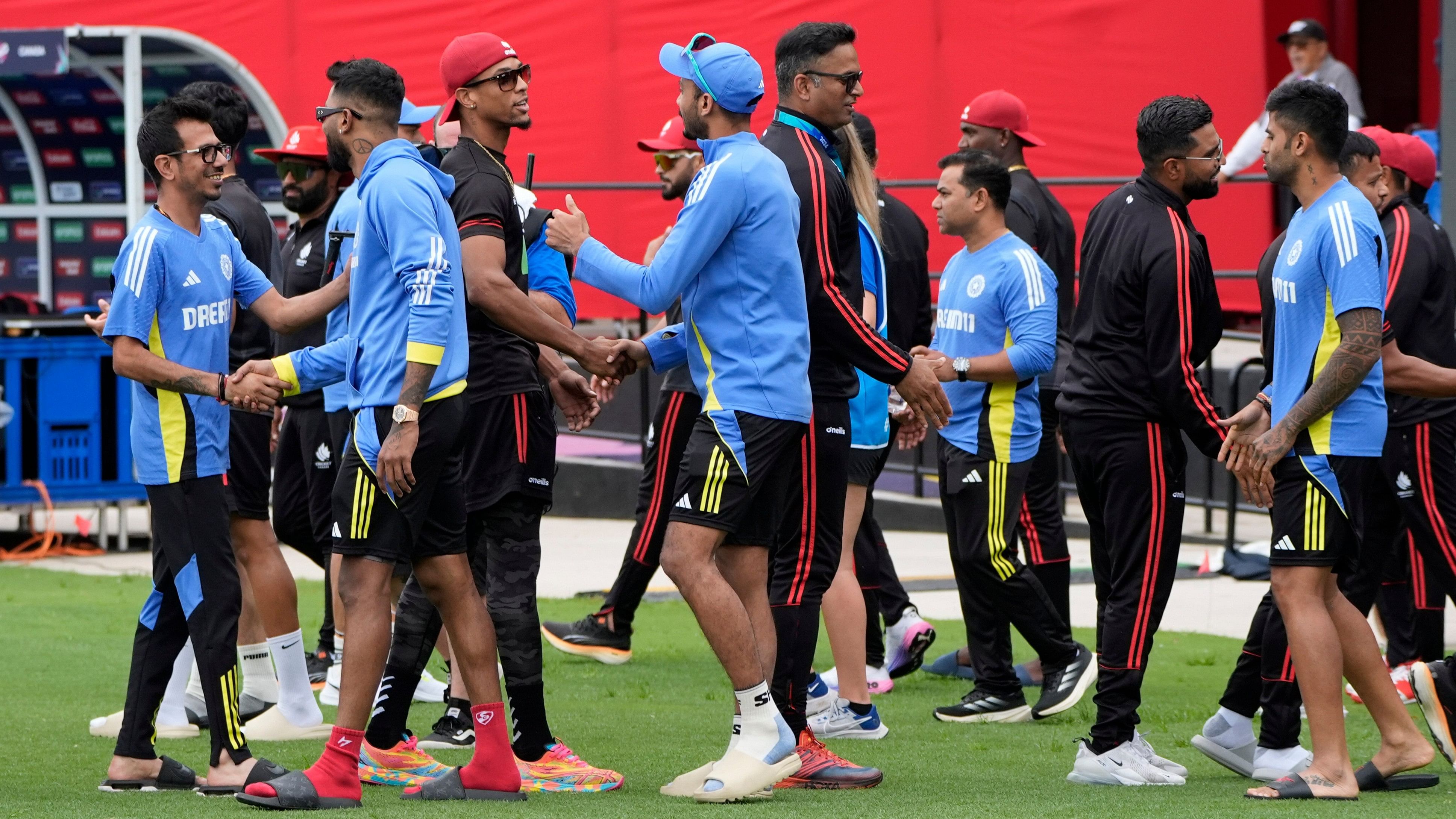 <div class="paragraphs"><p>Players of the two teams greet each other after the ICC Men's T20 World Cup cricket match between Canada and India was called off due to wet outfield at the Central Broward Regional Park Stadium, Lauderhill, Fla., Saturday, June 15, 2024.</p></div>