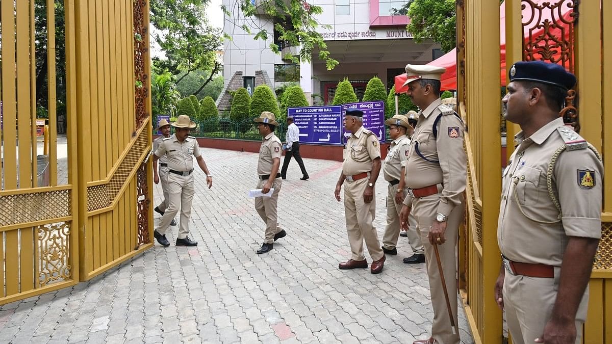 <div class="paragraphs"><p>Police personnel on standby at a vote counting centre in Mount Carmel College on Monday.&nbsp;</p></div>