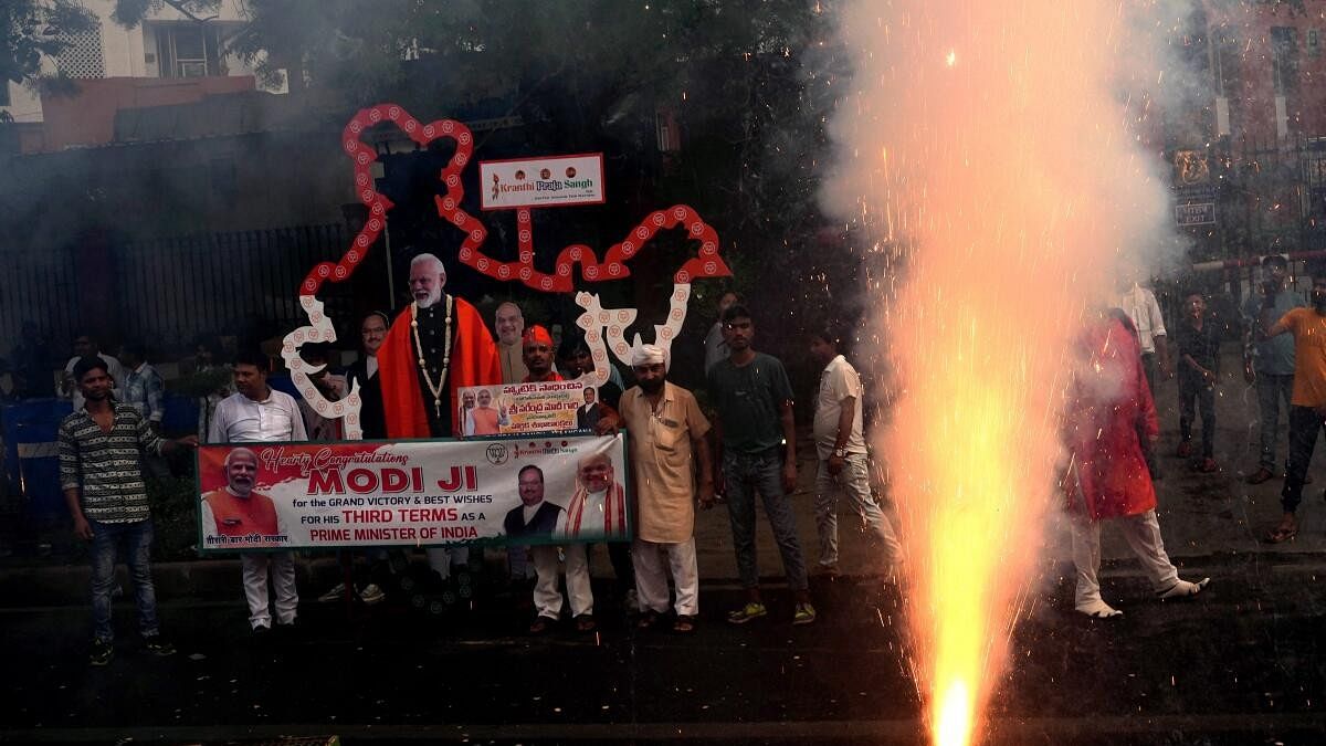 <div class="paragraphs"><p>Supporters celebrate during the arrival of Prime Minister Narendra Modi for a meeting at BJP headquarters as the party leads in the Lok Sabha elections amid the counting of votes, in New Delhi, Tuesday, June 4.</p></div>