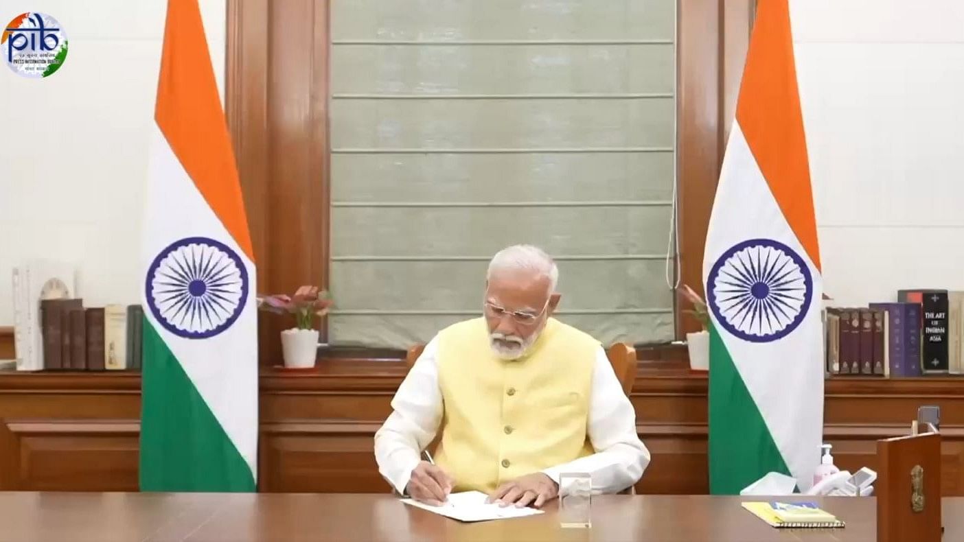<div class="paragraphs"><p>Screengrab from a video showing PM Modi signing his first file, starting off his third term.</p></div>