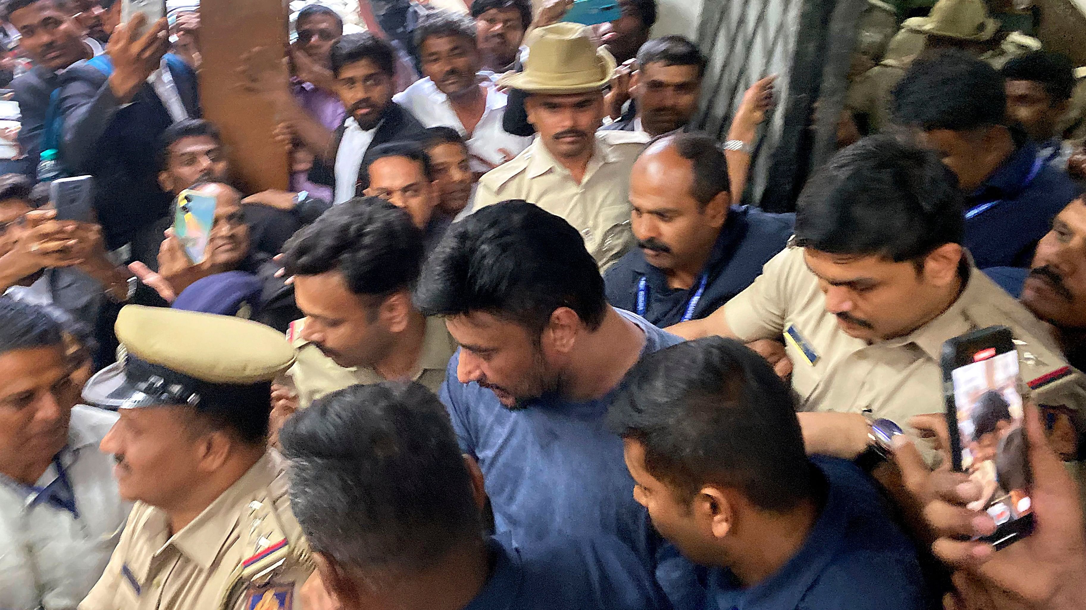 <div class="paragraphs"><p>Actor Darshan being taken to a Bengaluru court in connection with the Renukaswamy murder case,.</p></div>