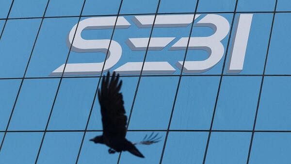 <div class="paragraphs"><p>A bird flies past the new logo of the Securities and Exchange Board of India (SEBI) at its headquarters in Mumbai, Maharashtra.</p></div>