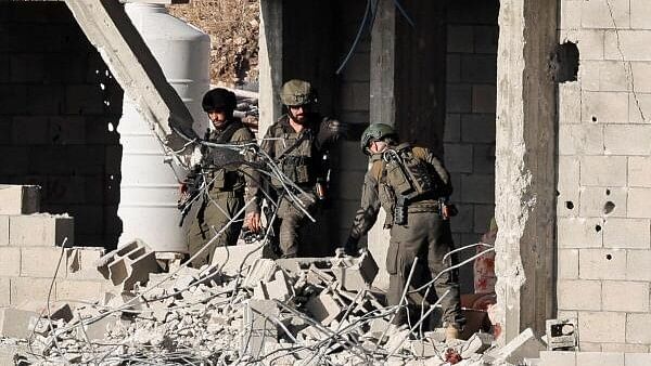 <div class="paragraphs"><p>Israeli soldiers look on, during a military operation, in Qabatiya, near Jenin, in the Israeli-occupied West Bank.&nbsp;</p></div>