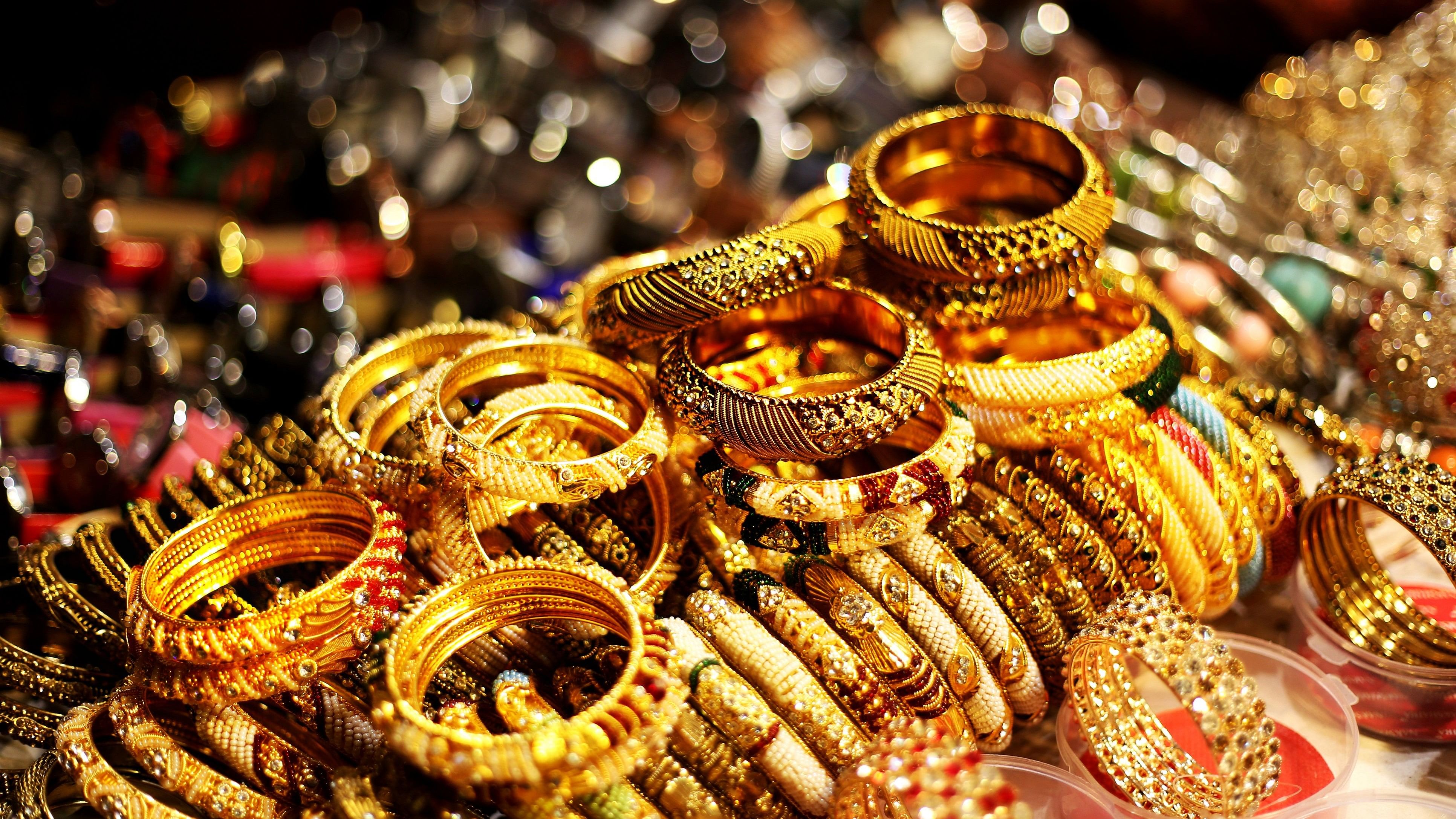 <div class="paragraphs"><p>Bracelets and bangles in a row in street market. Gold colored bracelets</p></div>