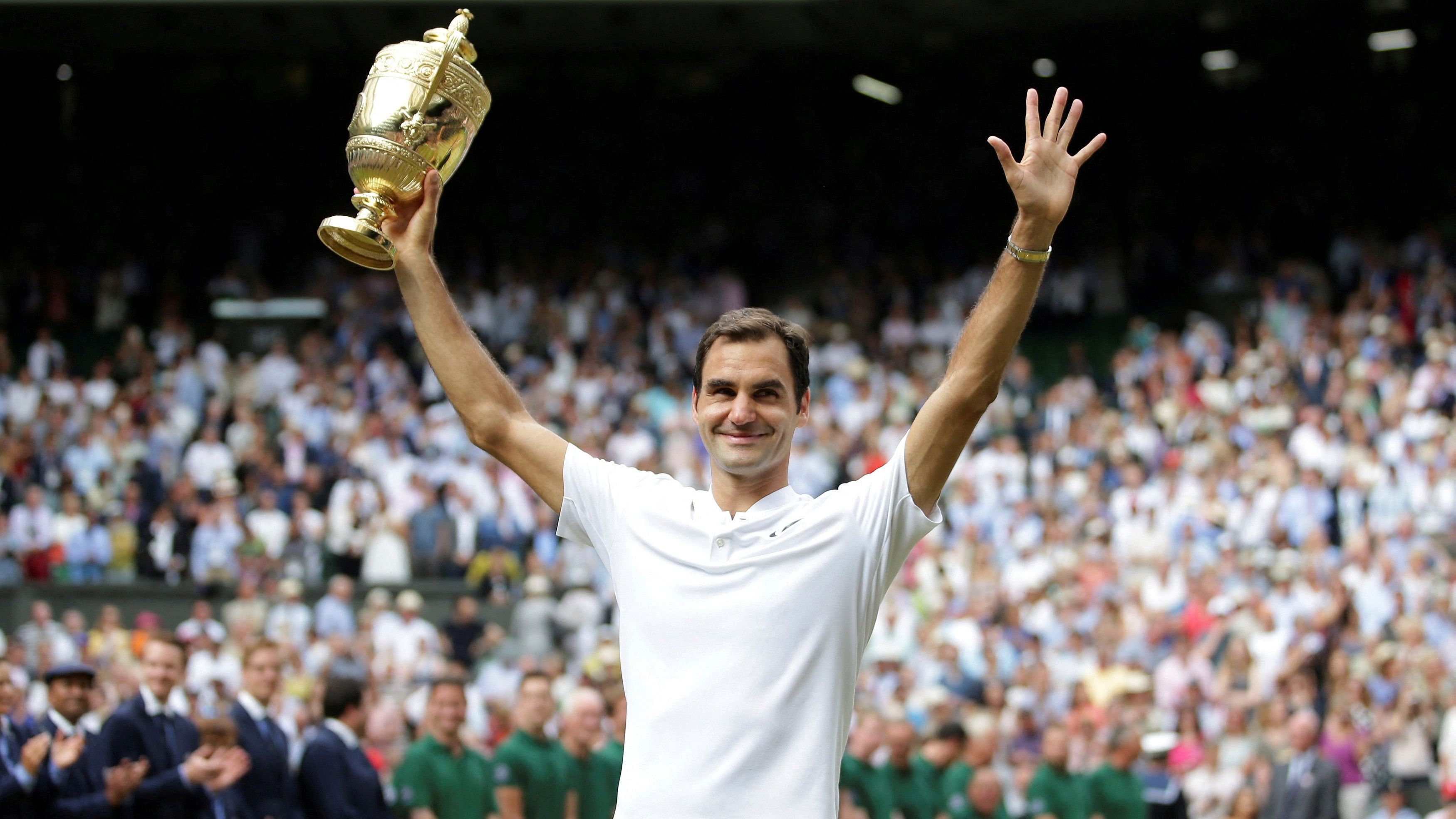 <div class="paragraphs"><p>Switzerland’s Roger Federer poses with the trophy as he celebrates winning the final against Croatia’s Marin Cilic.</p></div>