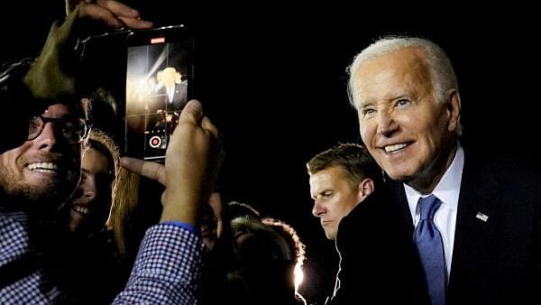 <div class="paragraphs"><p>US President Joe Biden poses for a recording as he greets supporters on arrival at Raleigh-Durham International Airport in Raleigh, North Carolina</p></div>