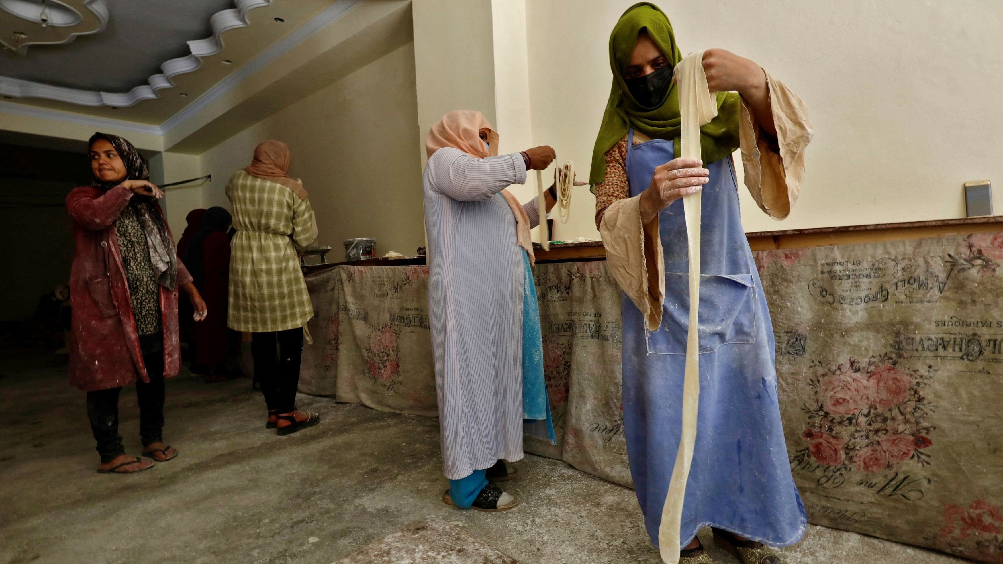 <div class="paragraphs"><p>Afghan women prepare dough to make traditional cookies inside a bakery.</p></div>