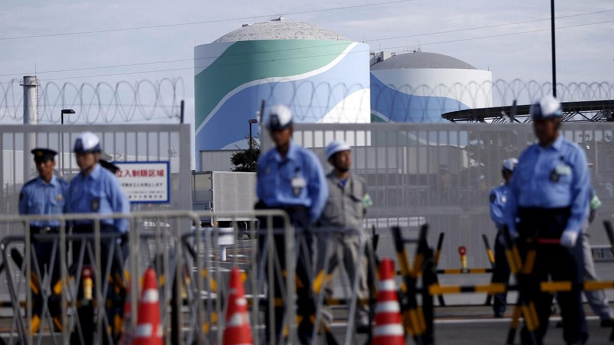 <div class="paragraphs"><p>A file image of&nbsp;security personnel standing guard in front of Kyushu Electric Power's Sendai nuclear power station in Japan.</p></div>