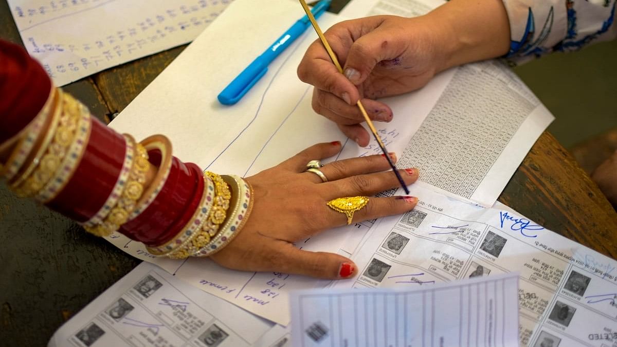 <div class="paragraphs"><p> A voter gets her finger marked with indelible ink before casting her vote for the seventh and last phase of Lok Sabha elections.</p></div>