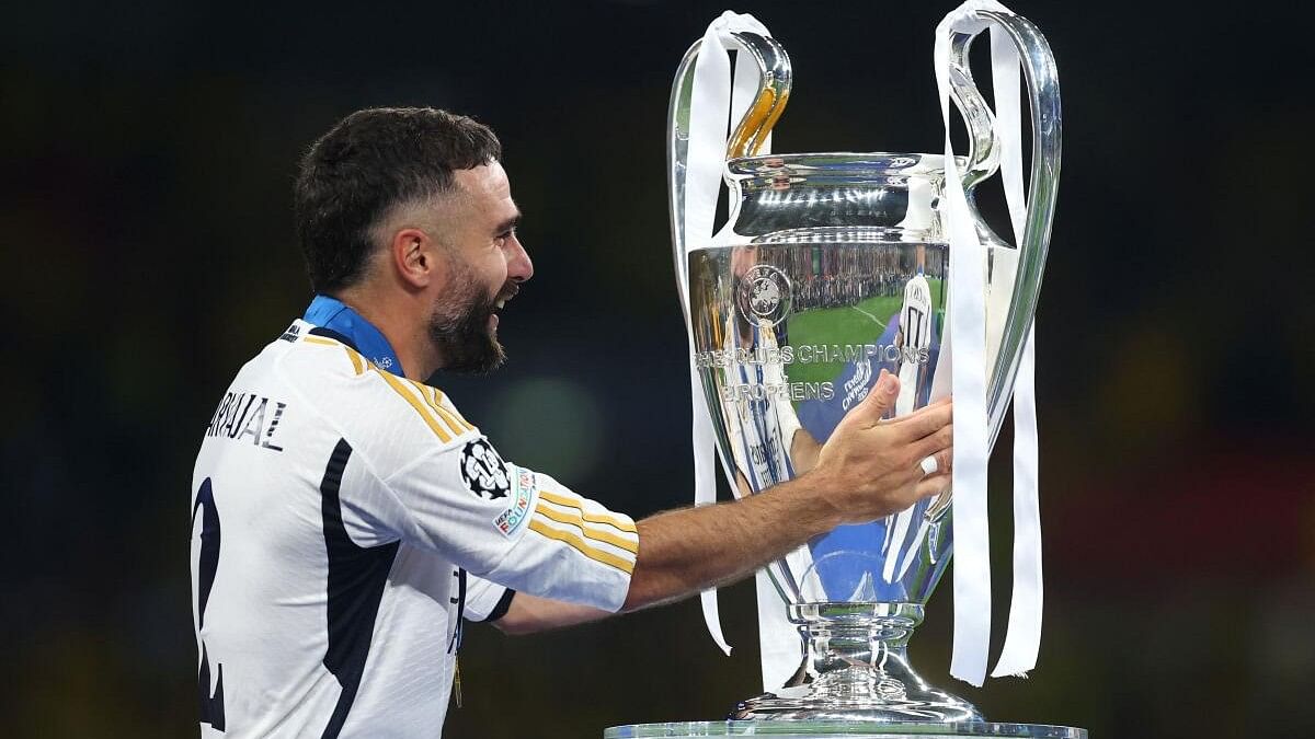 <div class="paragraphs"><p>Real Madrid's Dani Carvajal celebrates with the trophy after receiving his medal after winning the Champions League final.&nbsp;</p></div>