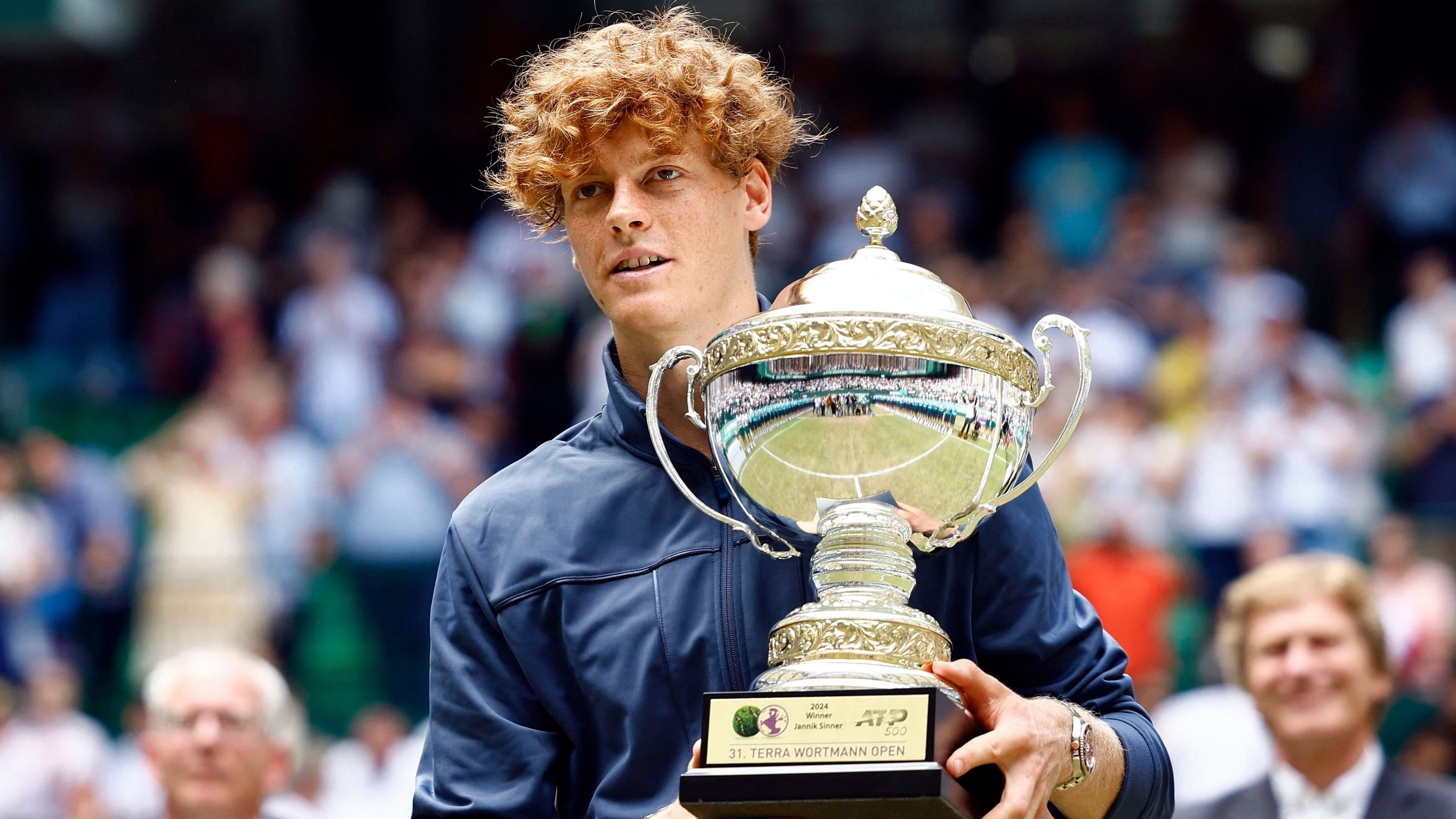 <div class="paragraphs"><p> Italy's Jannik Sinner poses with the trophy after winning the final against Poland's Hubert Hurkacz </p></div>