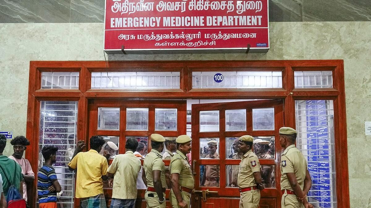 <div class="paragraphs"><p>Police personnel and others stand outside the emergency medicine department at a government hospital where patients are being treated after consuming spurious liquor, in Kallakurichi, Friday, June 21, 2024.</p></div>
