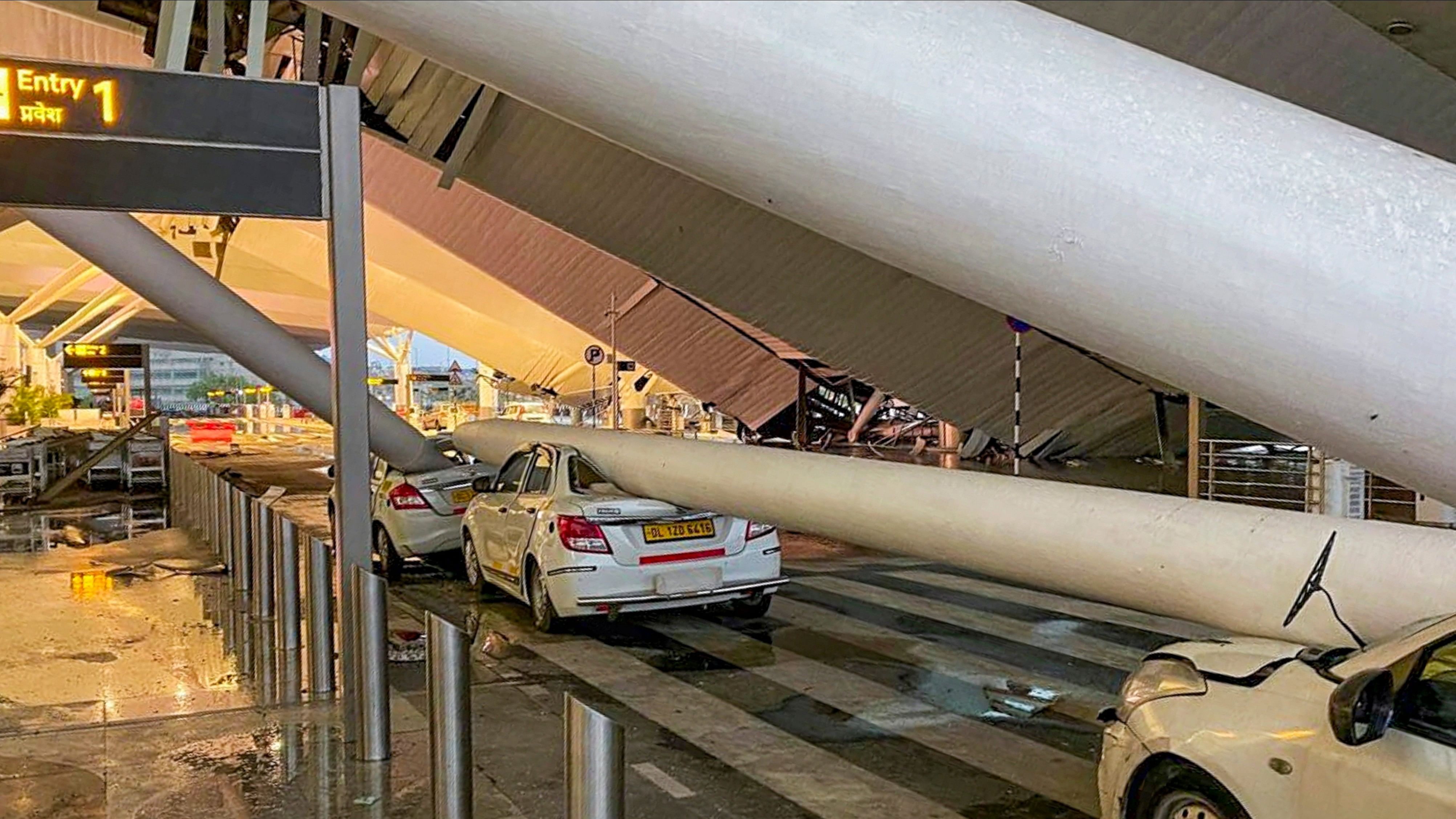 <div class="paragraphs"><p>Vehicles are crushed after a portion of the roof at the Delhi airport's Terminal-1 collapsed.</p></div>