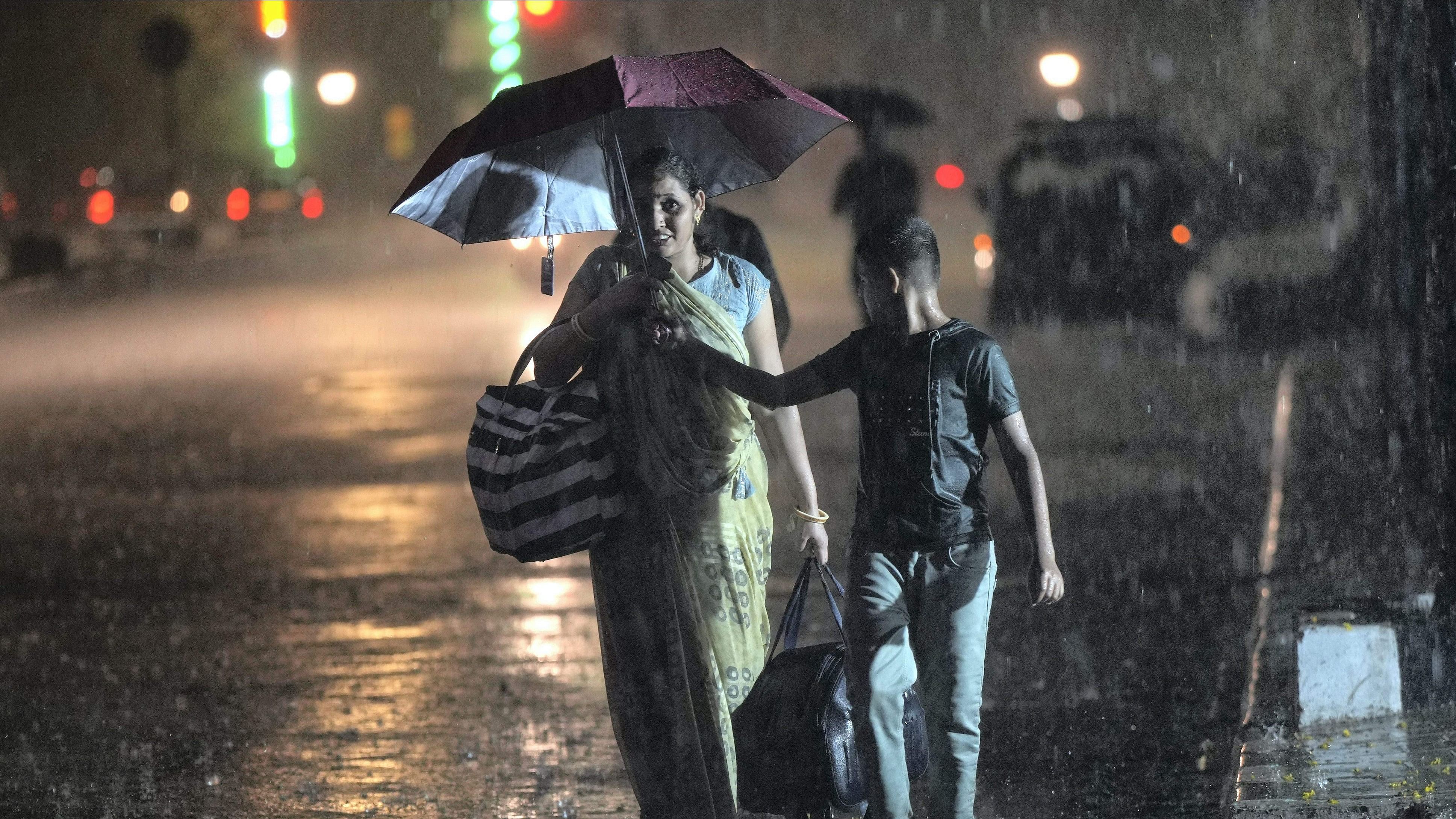 <div class="paragraphs"><p>A pedestrian uses an umbrella to shield herself during rains, outside CSMT in Mumbai, Sunday, June 9, 2024.</p></div>