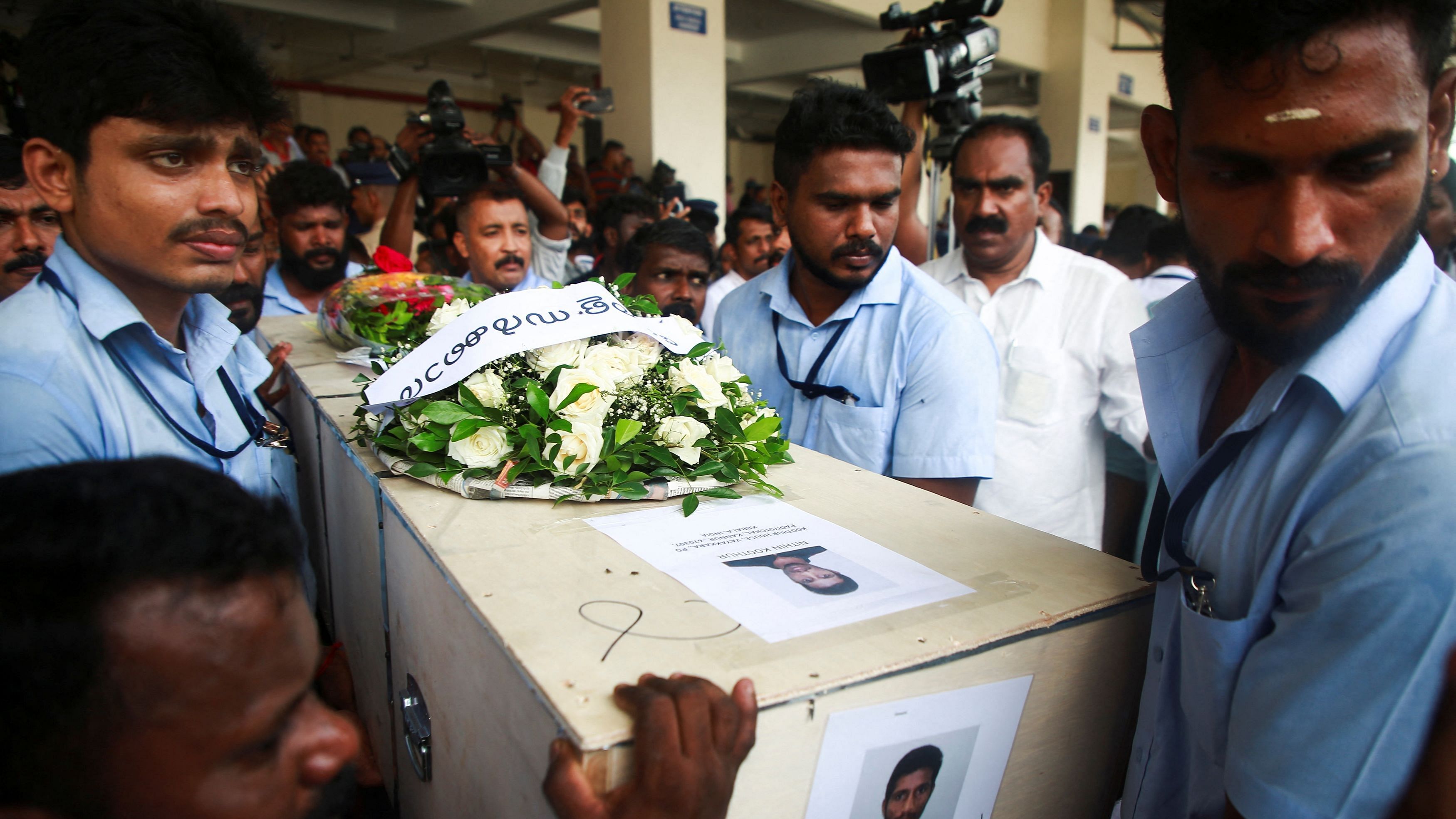 <div class="paragraphs"><p>Officials carry a coffin containing the body of a victim who died during a fire that broke out in a building housing foreign workers in Kuwait, at Cochin International Airport, in Kochi on Friday.</p></div>