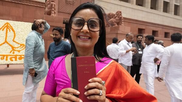 <div class="paragraphs"><p>TMC MP Mahua Moitra holds a copy of the Constitution of India at the Parliament House complex on the first day of the first session of the 18th Lok Sabha, in New Delhi, Monday, June 24, 2024.</p></div>