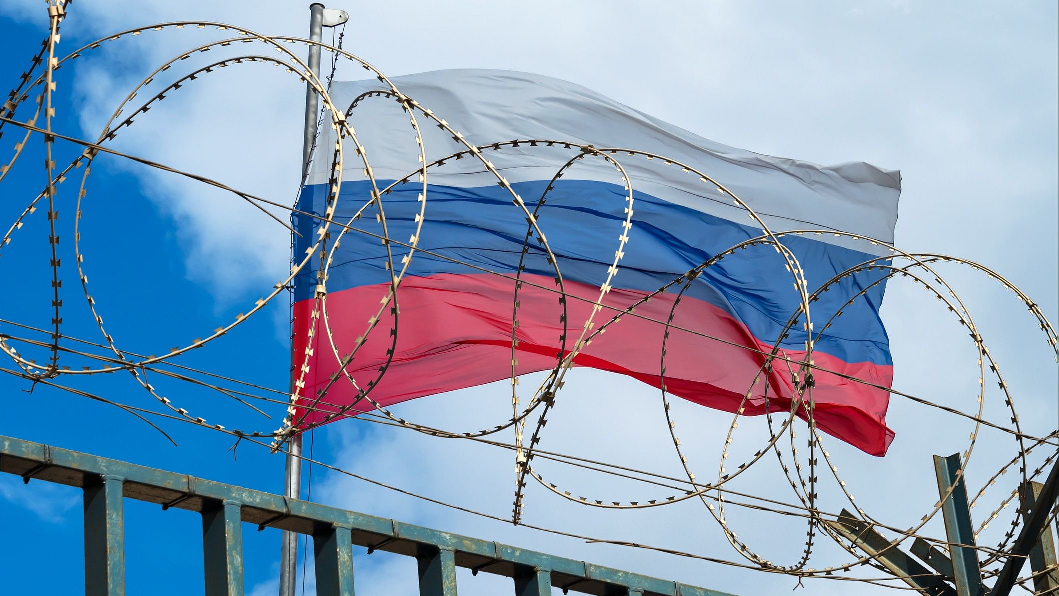 <div class="paragraphs"><p>View of russian flag behind barbed wire.</p></div>