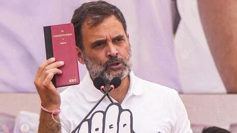 <div class="paragraphs"><p>Congress leader and candidate from Rae Bareli constituency Rahul Gandhi holds a copy of the constitution of India while addressing a public meeting at Dilshad Garden for the Lok Sabha elections</p></div>