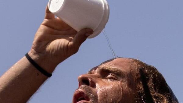 <div class="paragraphs"><p>A man pours water on his head</p></div>