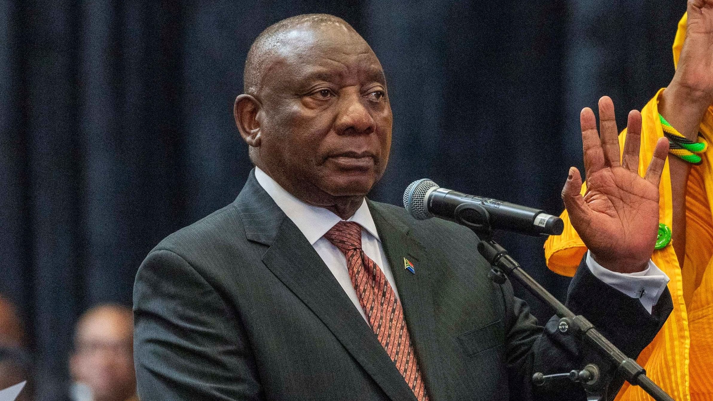 <div class="paragraphs"><p>South African president Cyril Ramaphosa raises his hand as he is sworn is as a member of Parliament ahead of an expected vote by lawmakers to decide if he is reelected as leader of the country in Cape Town, South Africa, Friday, June 14, 2024. </p></div>
