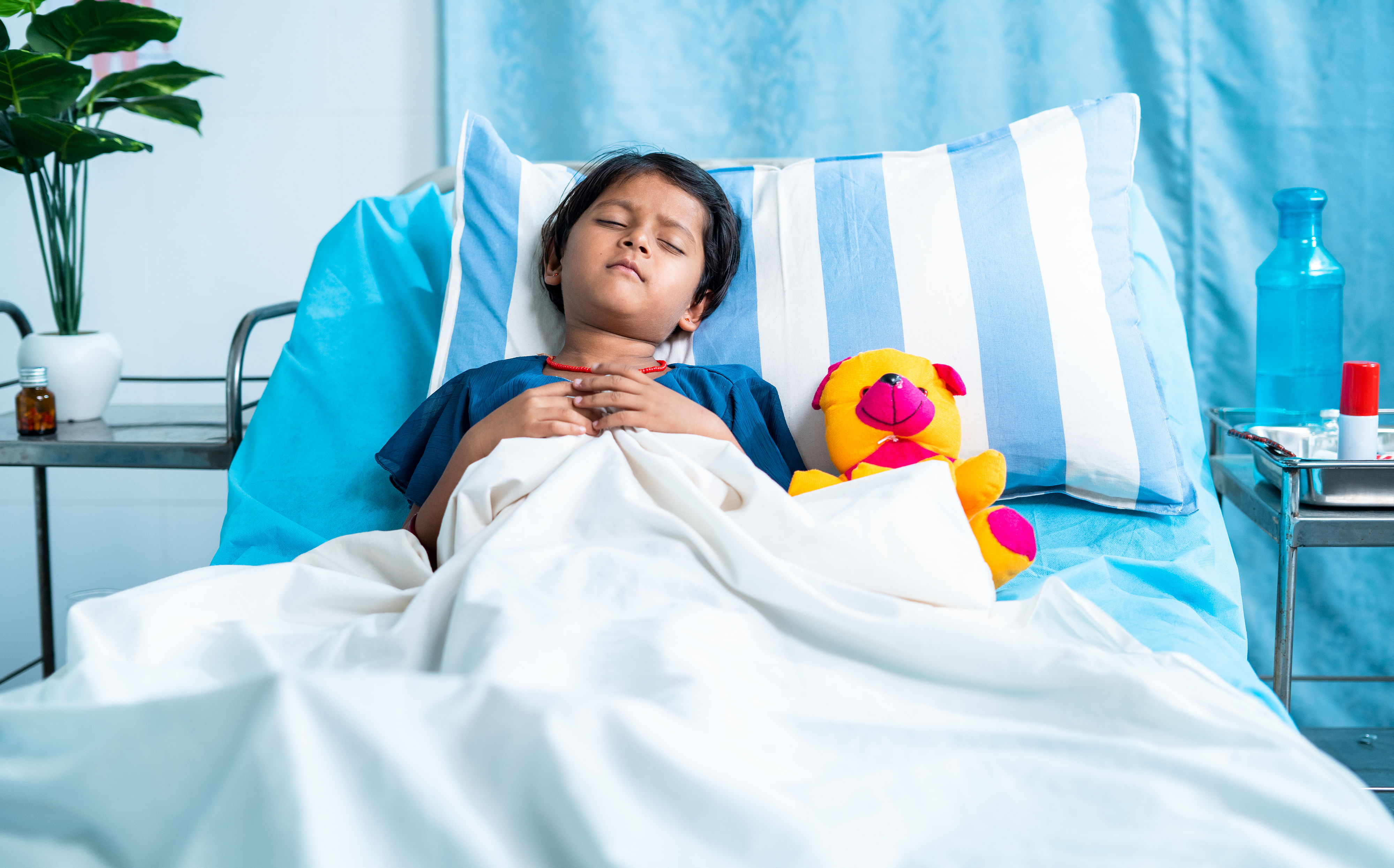 Sick girl child with teddy bear sleeping on bed at hospital - concept of medial treatment, illness and childcare
Children and Fever