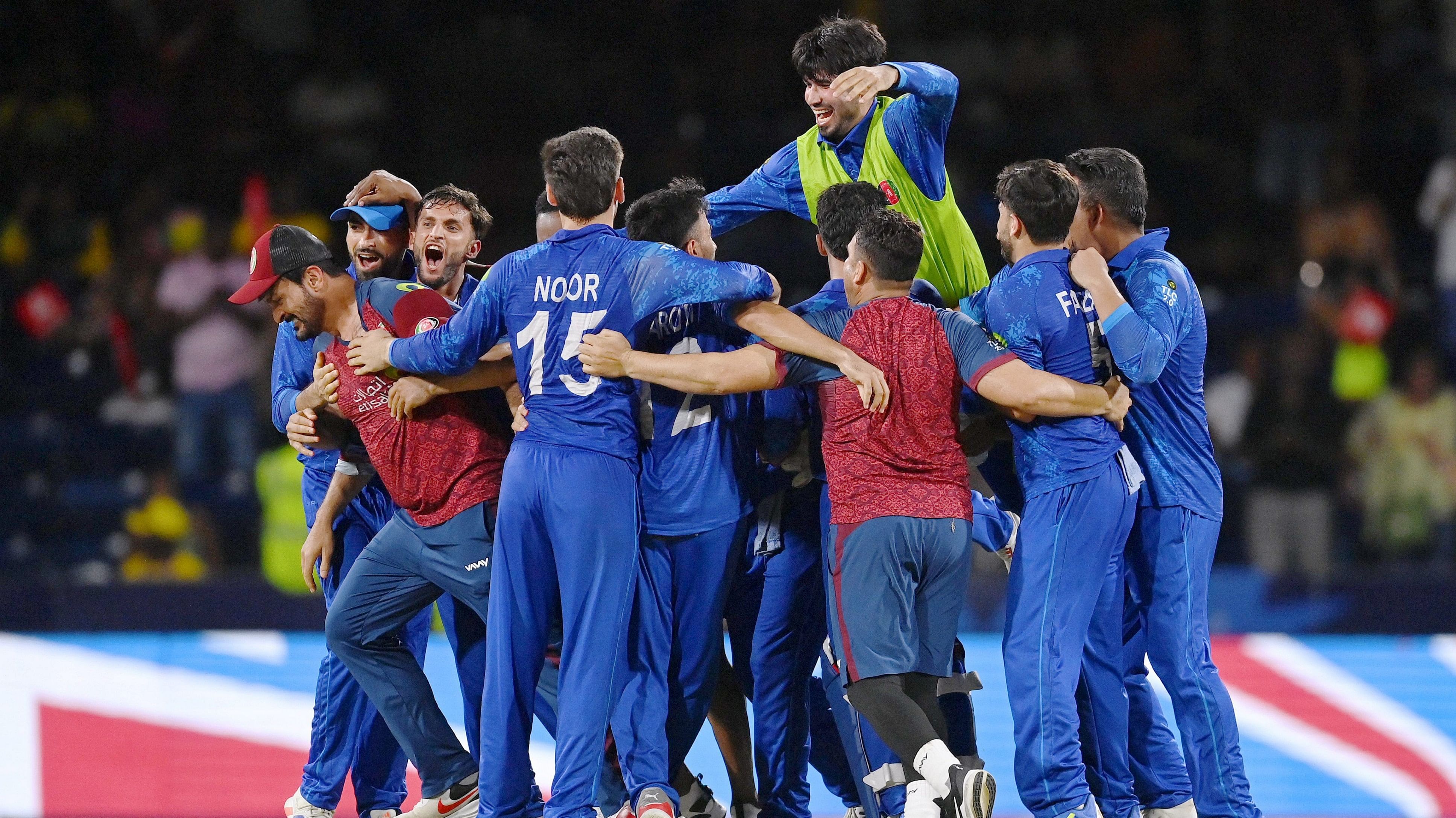 <div class="paragraphs"><p>Afghanistan's players celebrate after winning their the ICC Men's T20 World Cup cricket match against Australia, at Arnos Vale Ground, Kingstown, Saint Vincent and the Grenadines, Saturday, June 22, 2024.</p></div>