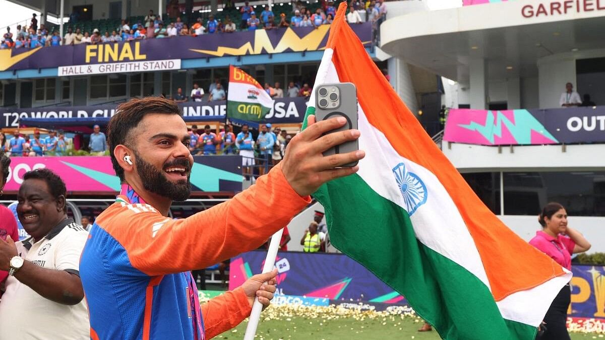 <div class="paragraphs"><p>Virat Kohli takes a selfie as he celebrates with the Tricolour after winning the T20 World Cup</p></div>