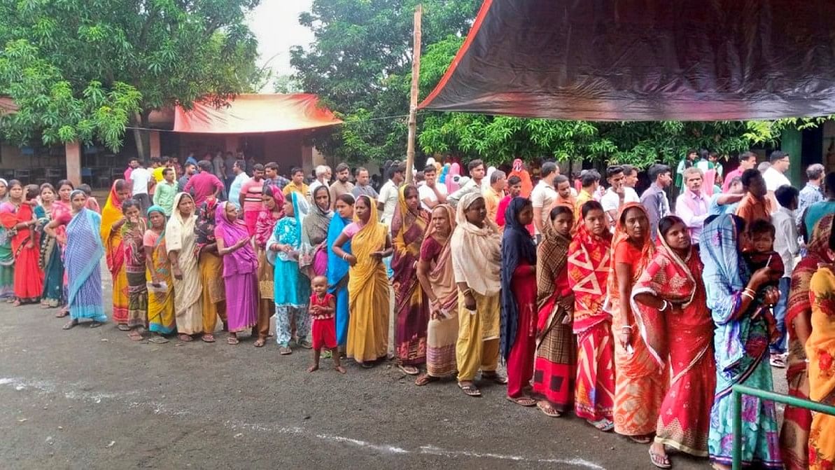 <div class="paragraphs"><p>People wait a polling station to cast their votes in Jharkhand.</p></div>