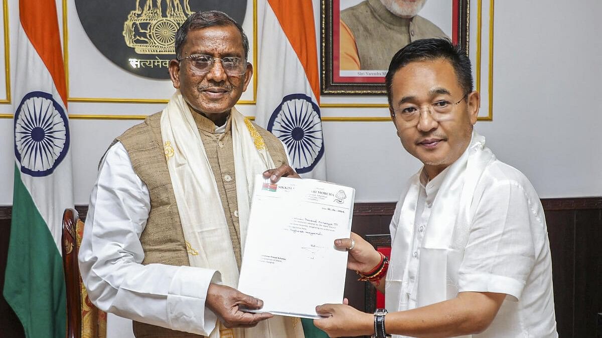 <div class="paragraphs"><p>Prem Singh Tamang (right) meets Governor Lakshman Prasad Acharya to stake claim to form the government in Sikkim. </p></div>