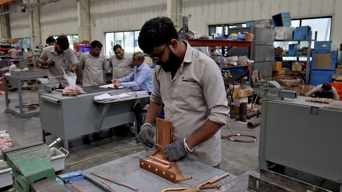 <div class="paragraphs"><p>File Photo: Employees assemble an electric transformer inside a manufacturing unit of Inductotherm (India) Private Limited at Sanand GIDC (Gujarat Industrial Development Corporation), on the outskirts of Ahmedabad.</p></div>