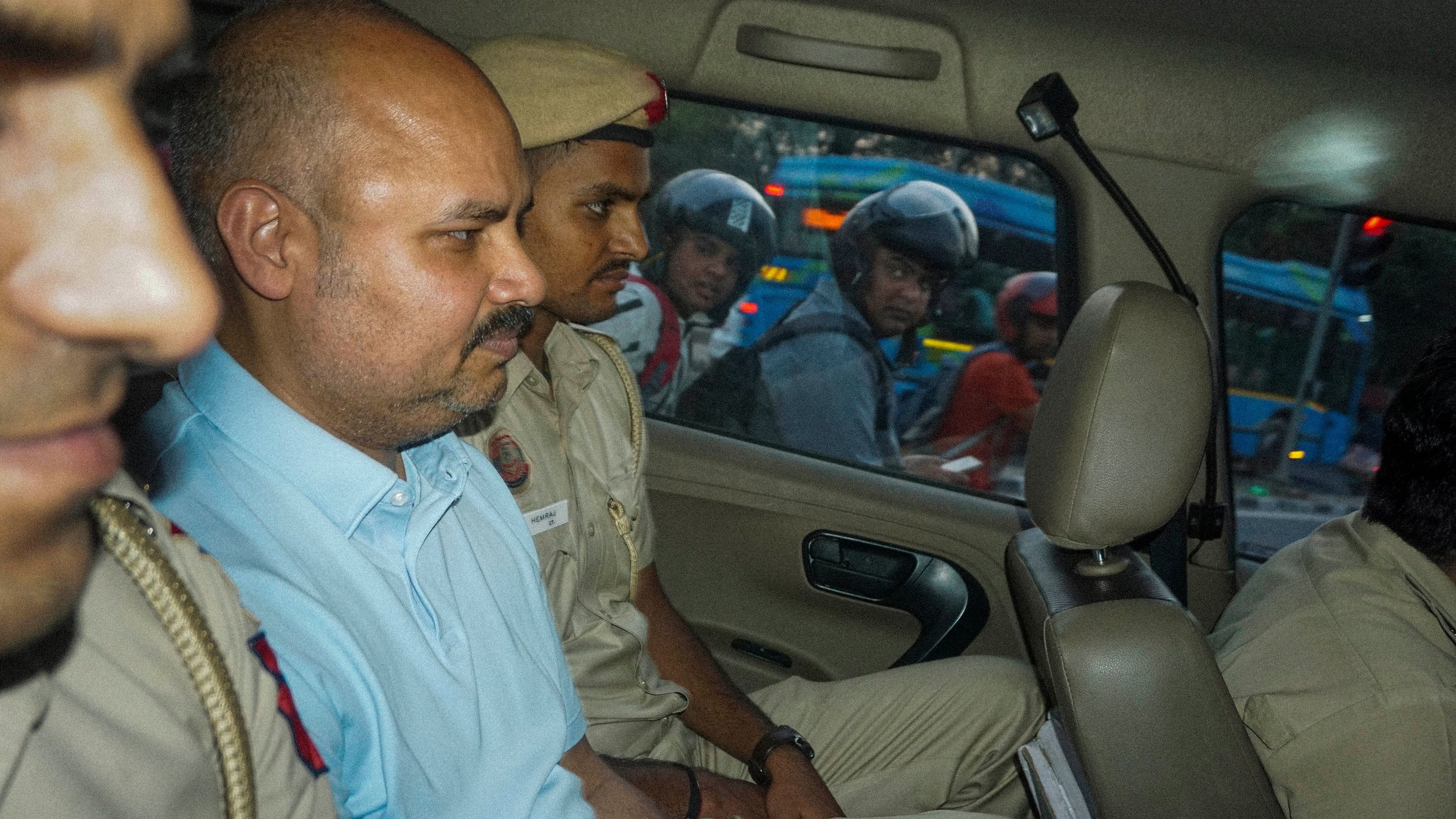 <div class="paragraphs"><p>Police personnel with Chief Minister Arvind Kejriwal's aide Bibhav Kumar in New Delhi.&nbsp;</p></div>