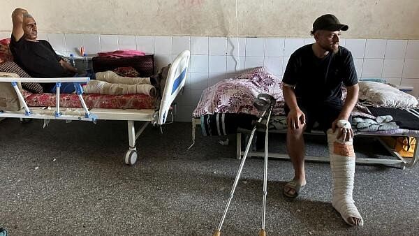 <div class="paragraphs"><p>Wounded Palestinians, who were injured in an Israeli strike, lie on beds as Gaza's overwhelmed Al-Aqsa hospital struggles to treat the wounded, amid the Israel-Hamas conflict, in Deir Al-Balah, in central Gaza Strip</p></div>