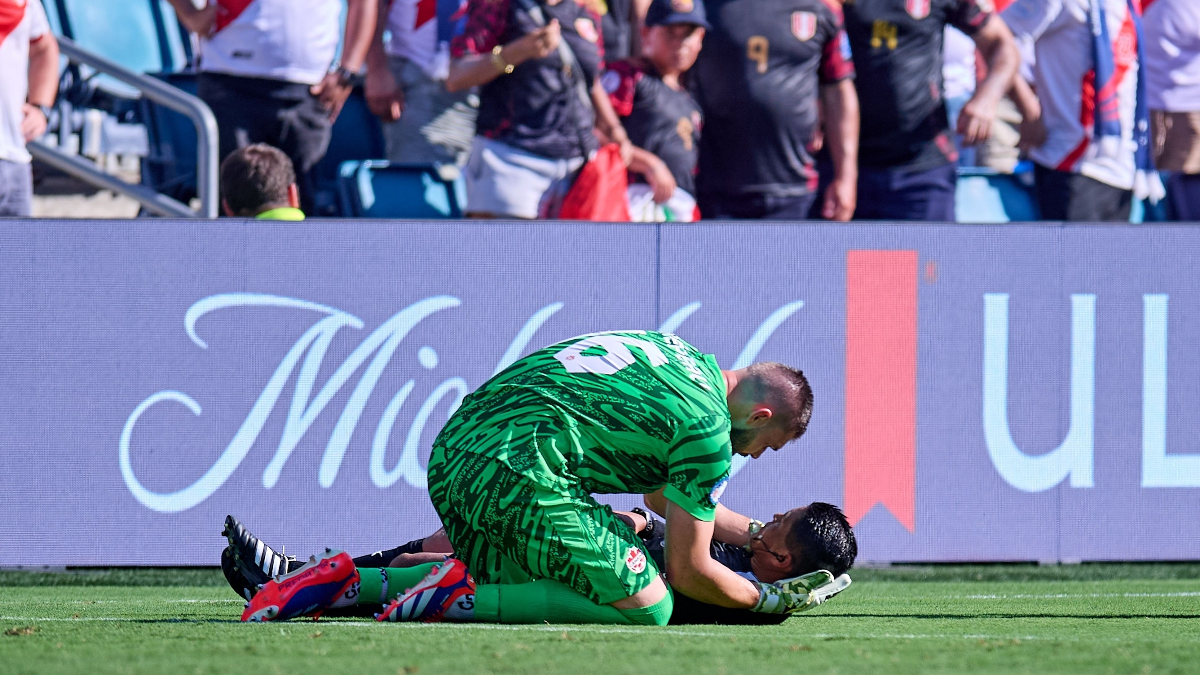 <div class="paragraphs"><p>Canada goalkeeper Maxime Crepeau attending Copa America assistant referee&nbsp;Humberto Panjoj after the later collapsed on the field&nbsp;during a Copa America match between Canada and Peru.</p></div>