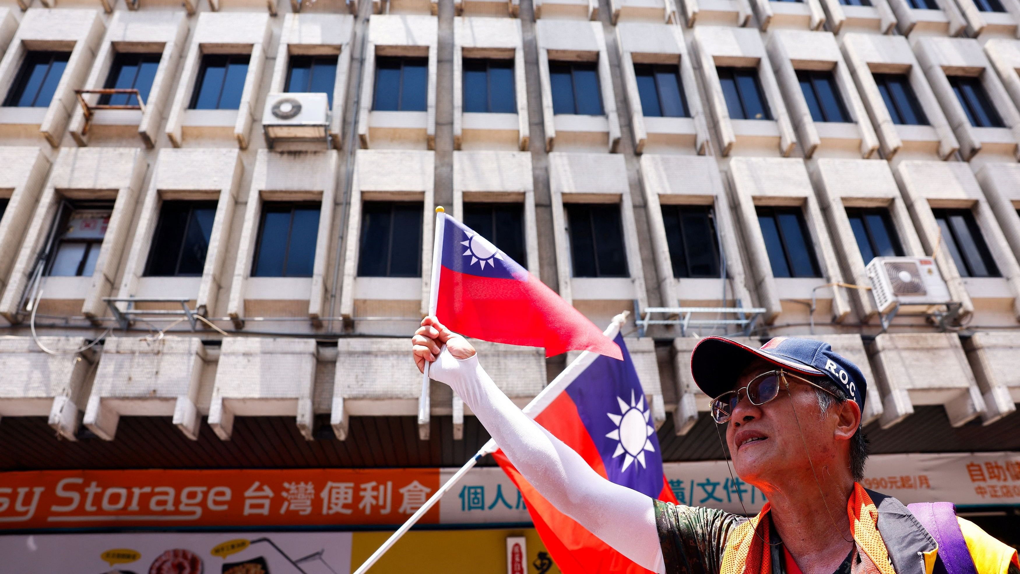 <div class="paragraphs"><p>A supporter of the Kuomintang party waves Taiwan flag outside of the parliament to show support, in Taipei.</p></div>