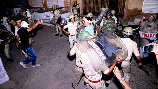 <div class="paragraphs"><p>Police personnel detain a person after stone pelting took place during a clash between two groups, in Jodhpur.&nbsp;</p></div>