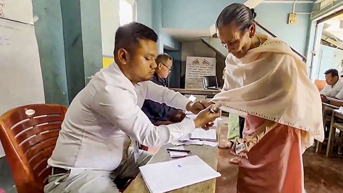 <div class="paragraphs"><p> Manipur: A voter gets her identification card checked to cast her vote for Lok Sabha elections at the Inner Manipur Lok Sabha constituency.</p></div>