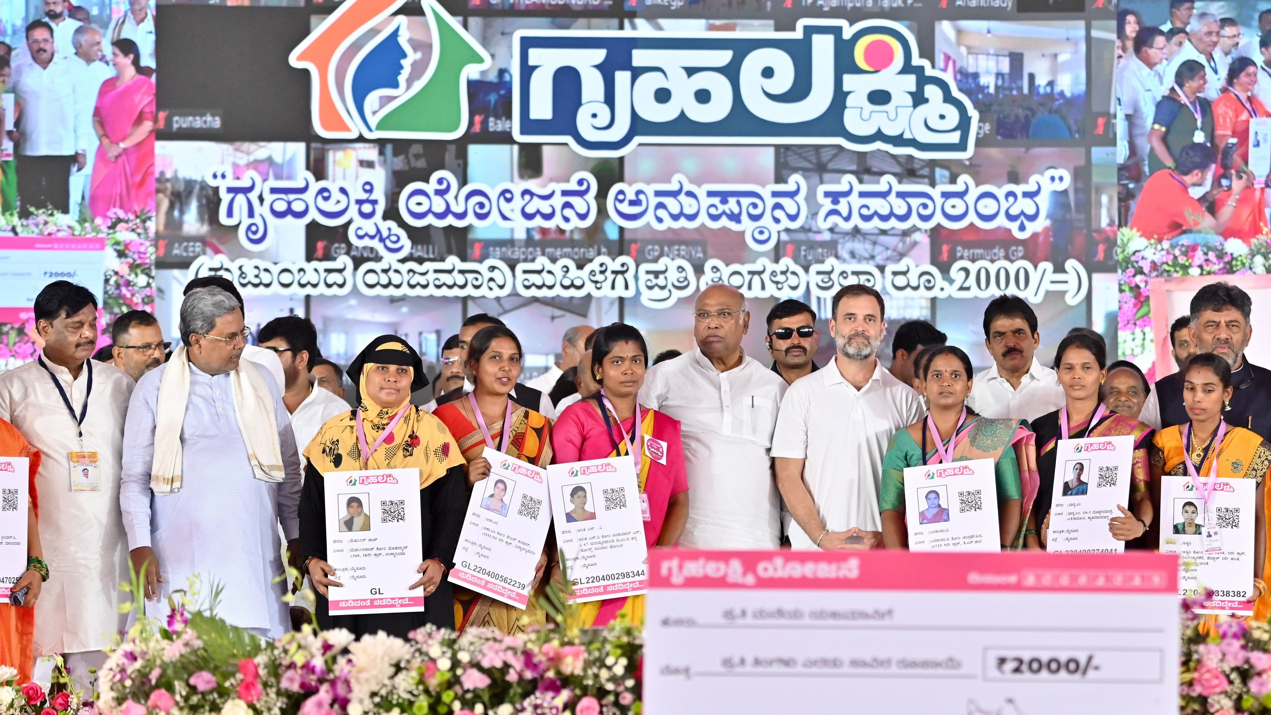 <div class="paragraphs"><p>Minister H C Mahadevappa, Chief Minister Siddaramaiah, Congress president Mallikarjun Kharge, Congress leader Rahul Gandhi, Deputy Chief Minister D K Shivakumar and others pose with the beneficiaries at the launch of the Rs 2,000-per month guarantee scheme for women in Mysuru last year. </p></div>