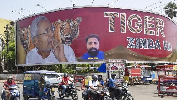 <div class="paragraphs"><p>JDU workers put up posters of party President and Bihar Chief Minister Nitish Kumar after the victory of NDA in the Lok Sabha elections, in Patna, Friday, June 7, 2024.</p></div>