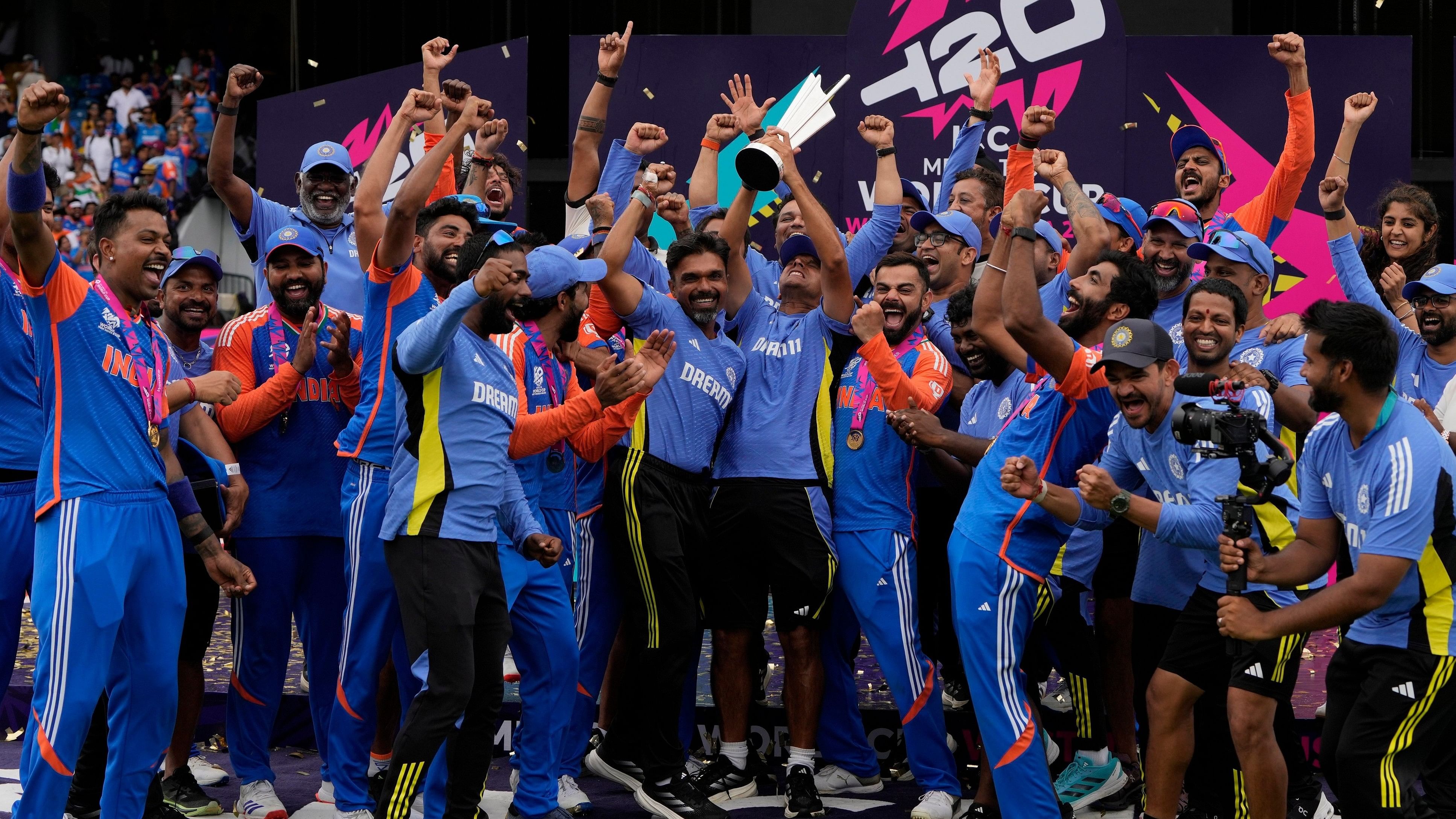 <div class="paragraphs"><p>India's head coach Rahul Dravid (centre) lifts the trophy as players celebrate winning the T20 World Cup after beating South Africa in the final on Saturday.</p></div>