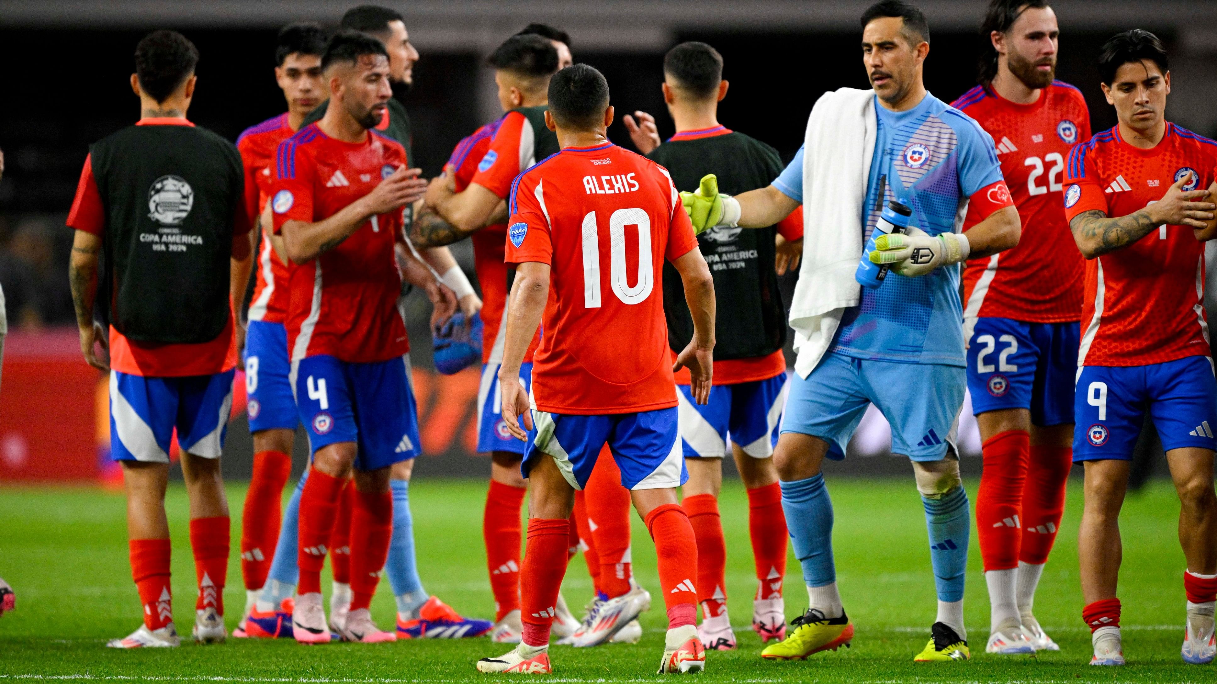 <div class="paragraphs"><p>The Chile team hugs on the field after they finish the game with a 0-0 draw with Peru in a 2024 Copa America match at AT&amp;T Stadium. </p></div>
