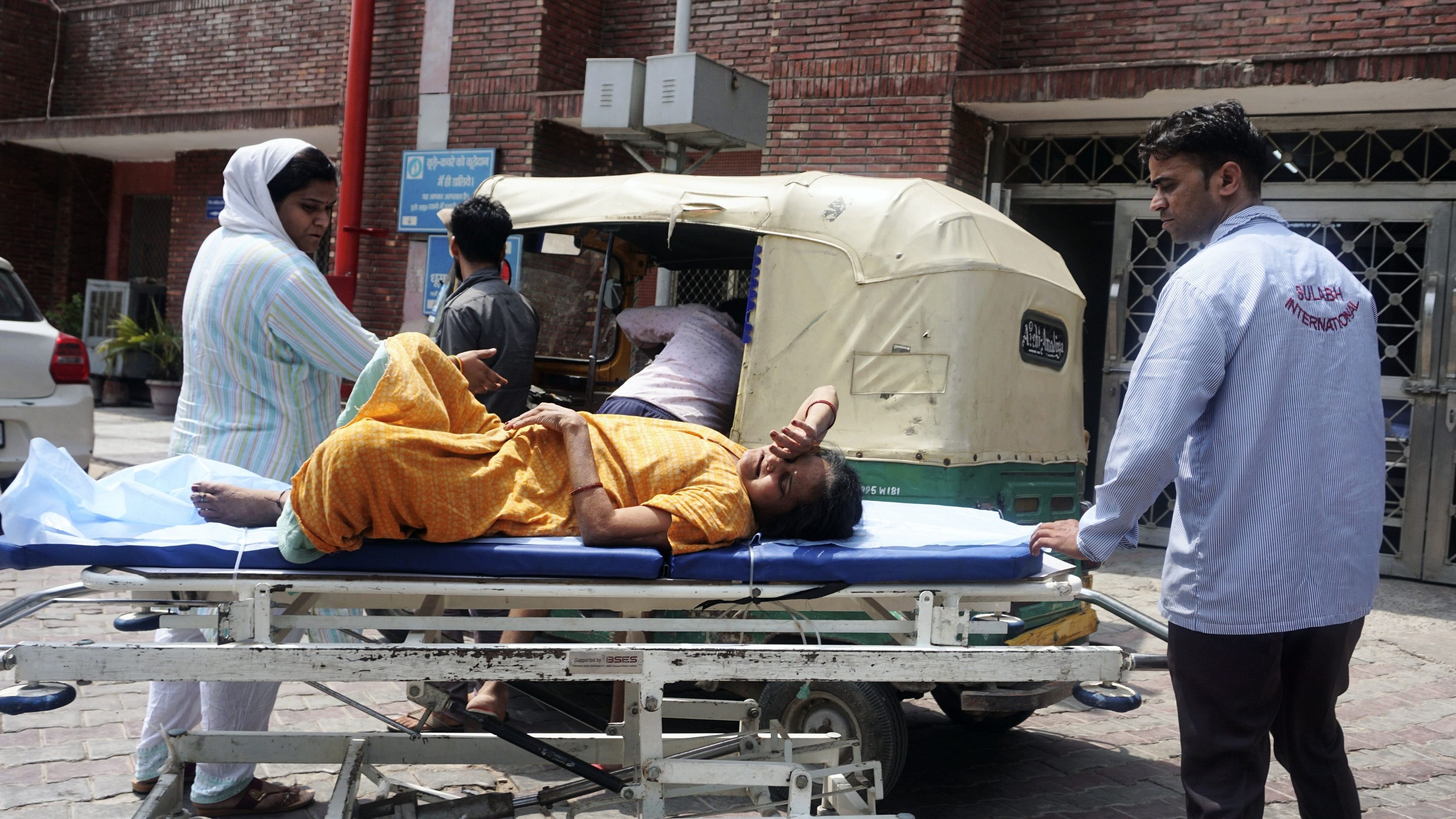 <div class="paragraphs"><p>A woman suffering from a heat-related illness being brought to LNJP Hospital for treatment, as the national capital witnesses hot weather conditions, in New Delhi, Thursday.</p></div>